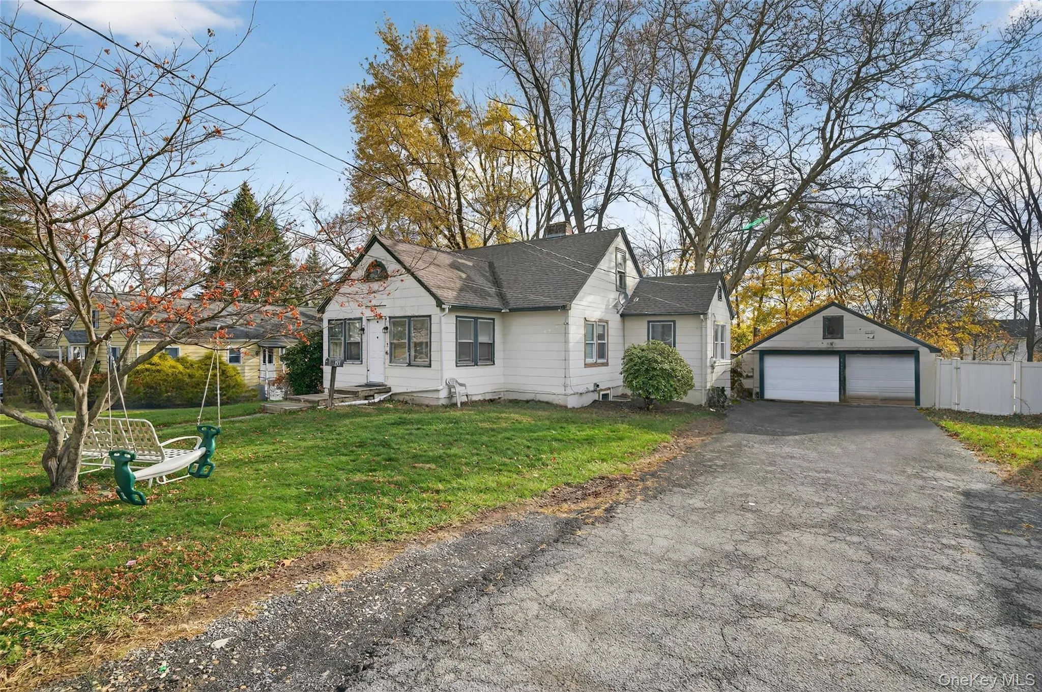 Bungalow-style home featuring an outbuilding, a garage, and roof with shingles Bungalow-style home featuring an outbuilding, a garage, and roof with shingles