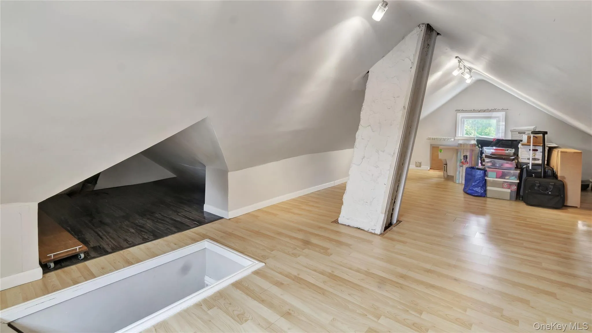 Bonus room with light wood-style flooring and vaulted ceiling Bonus room with light wood-style flooring and vaulted ceiling