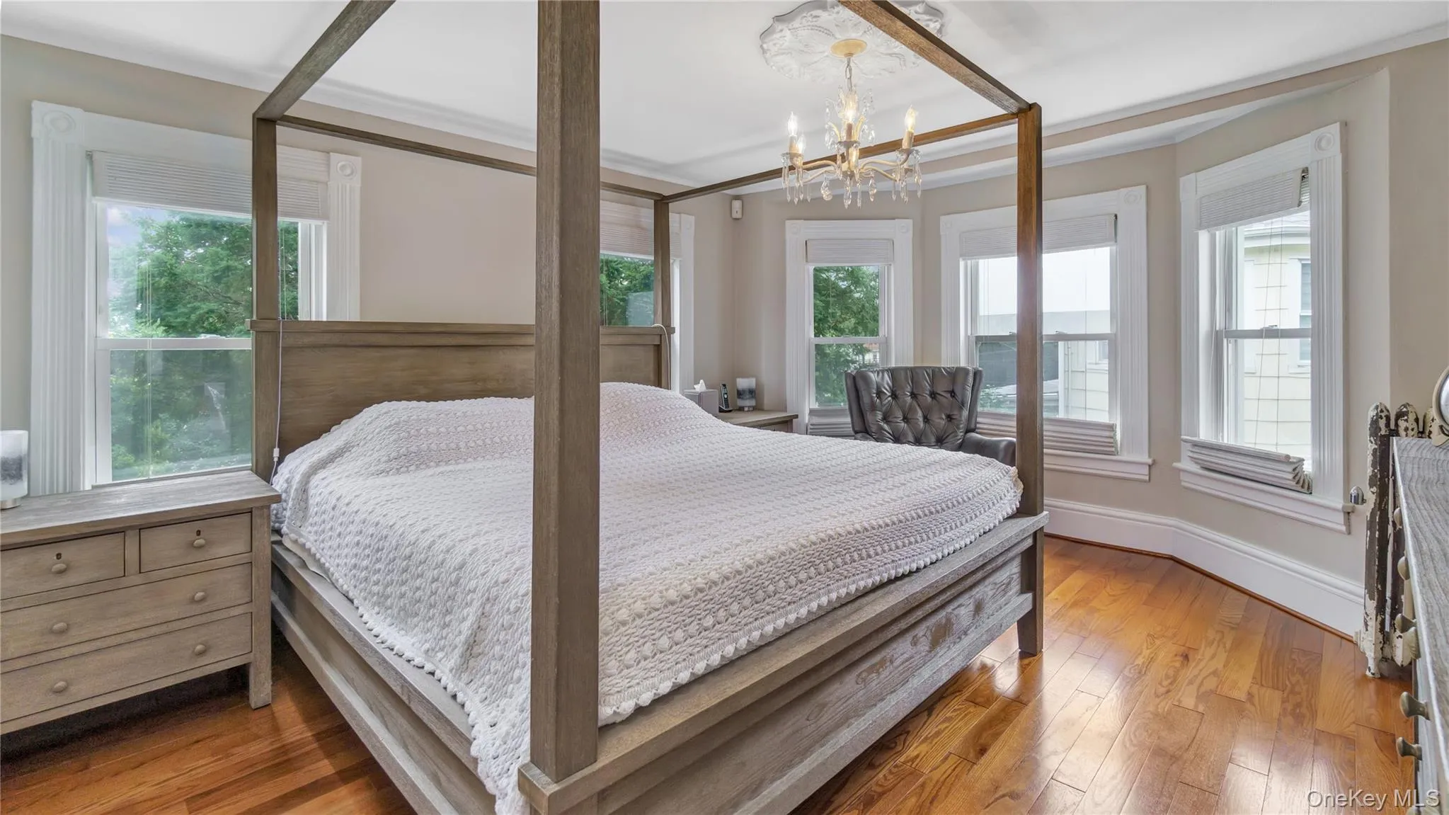 Bedroom with wood-type flooring and a chandelier Bedroom with wood-type flooring and a chandelier