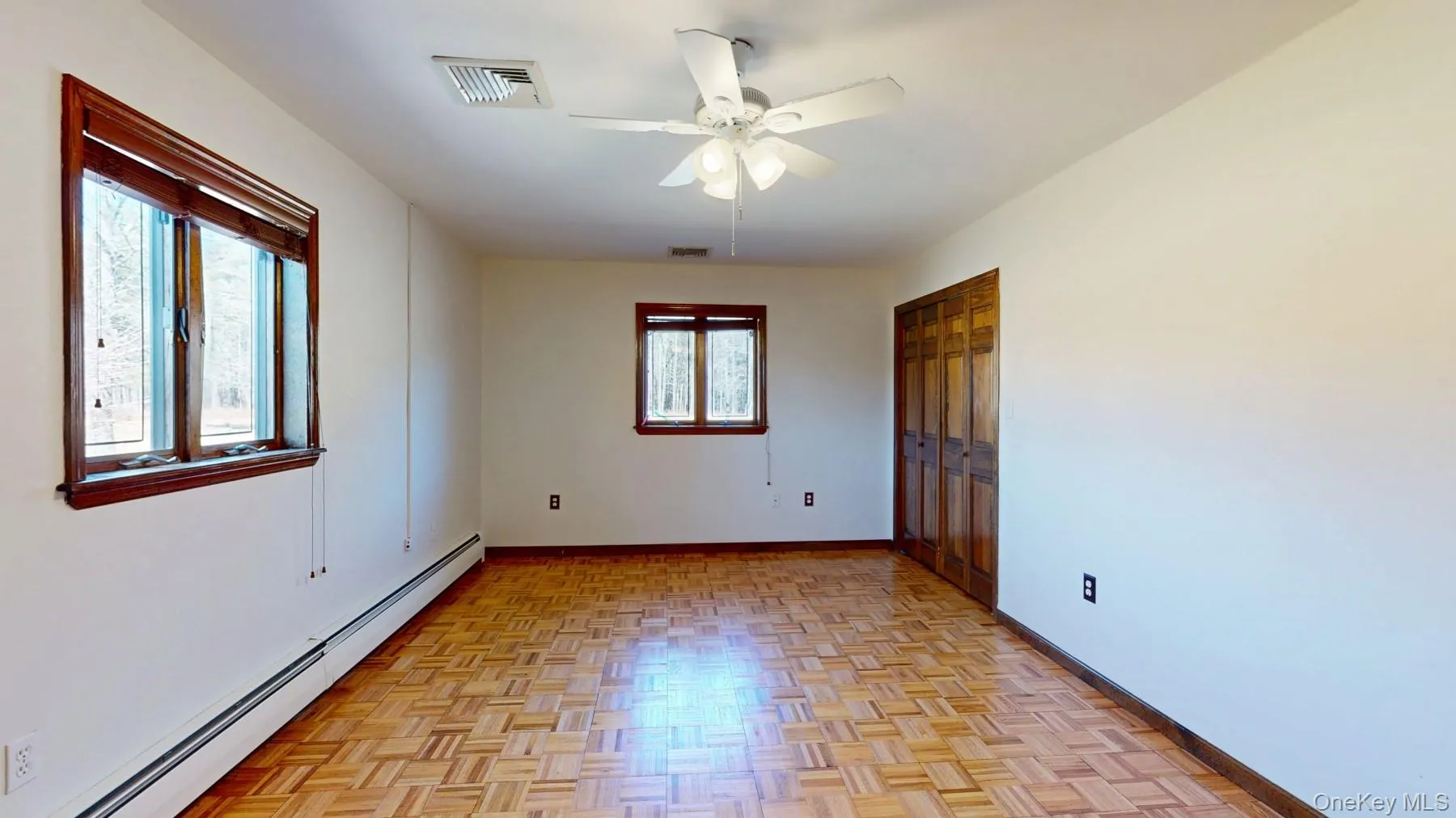 Unfurnished room featuring a baseboard radiator, baseboards, visible vents, and ceiling fan Unfurnished room featuring a baseboard radiator, baseboards, visible vents, and ceiling fan