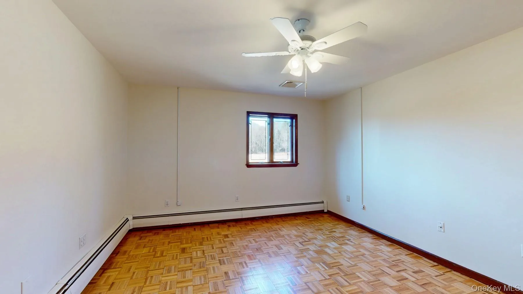 Unfurnished room featuring visible vents, baseboards, a baseboard heating unit, and ceiling fan Unfurnished room featuring visible vents, baseboards, a baseboard heating unit, and ceiling fan