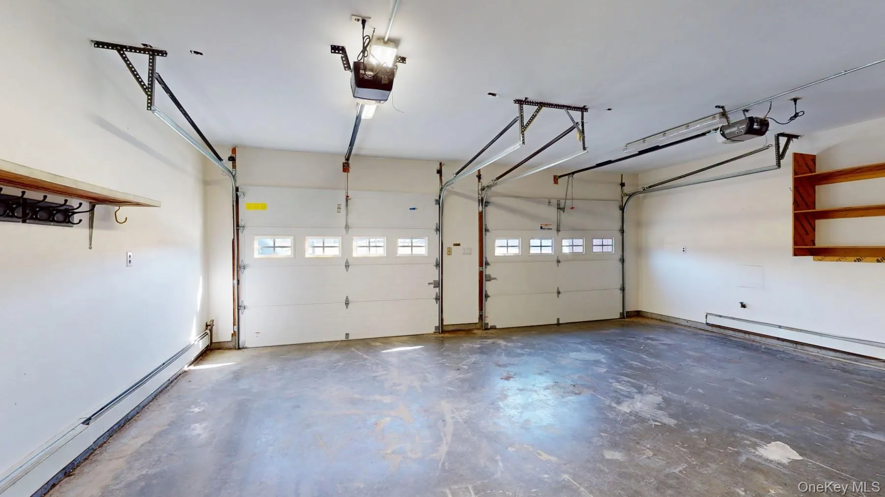Garage with a baseboard radiator and a garage door opener Garage with a baseboard radiator and a garage door opener