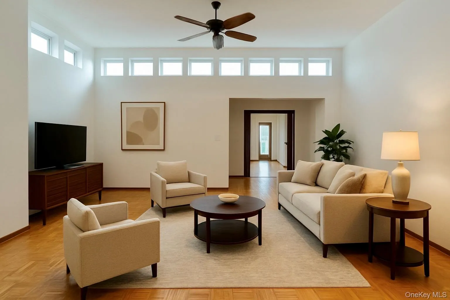 Living room featuring plenty of natural light and a ceiling fan(virtually staged) Living room featuring plenty of natural light and a ceiling fan(virtually staged)