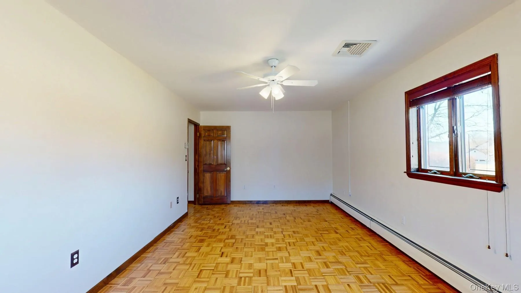 Unfurnished room featuring visible vents, baseboards, baseboard heating, and ceiling fan Unfurnished room featuring visible vents, baseboards, baseboard heating, and ceiling fan