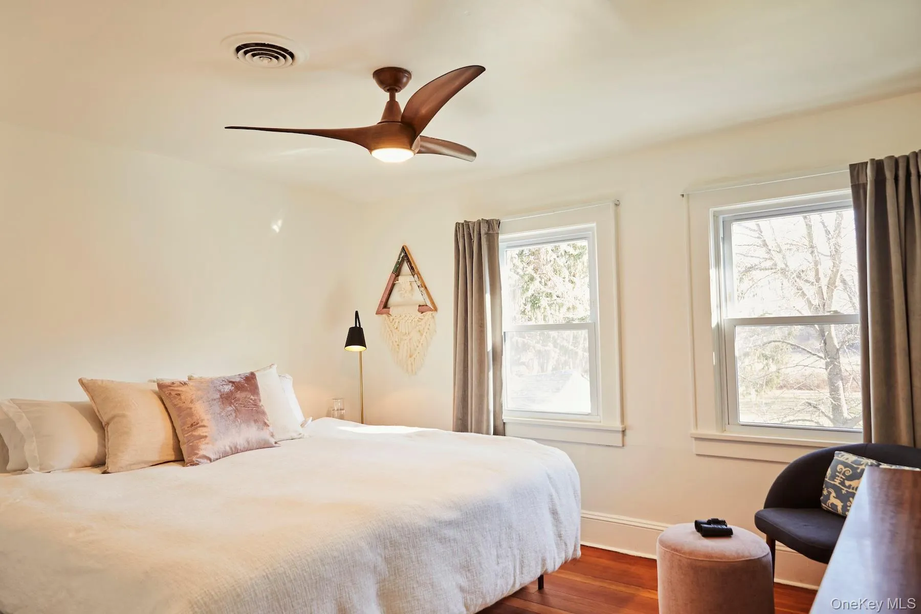 Bedroom featuring dark wood-style floors and a ceiling fan Bedroom featuring dark wood-style floors and a ceiling fan