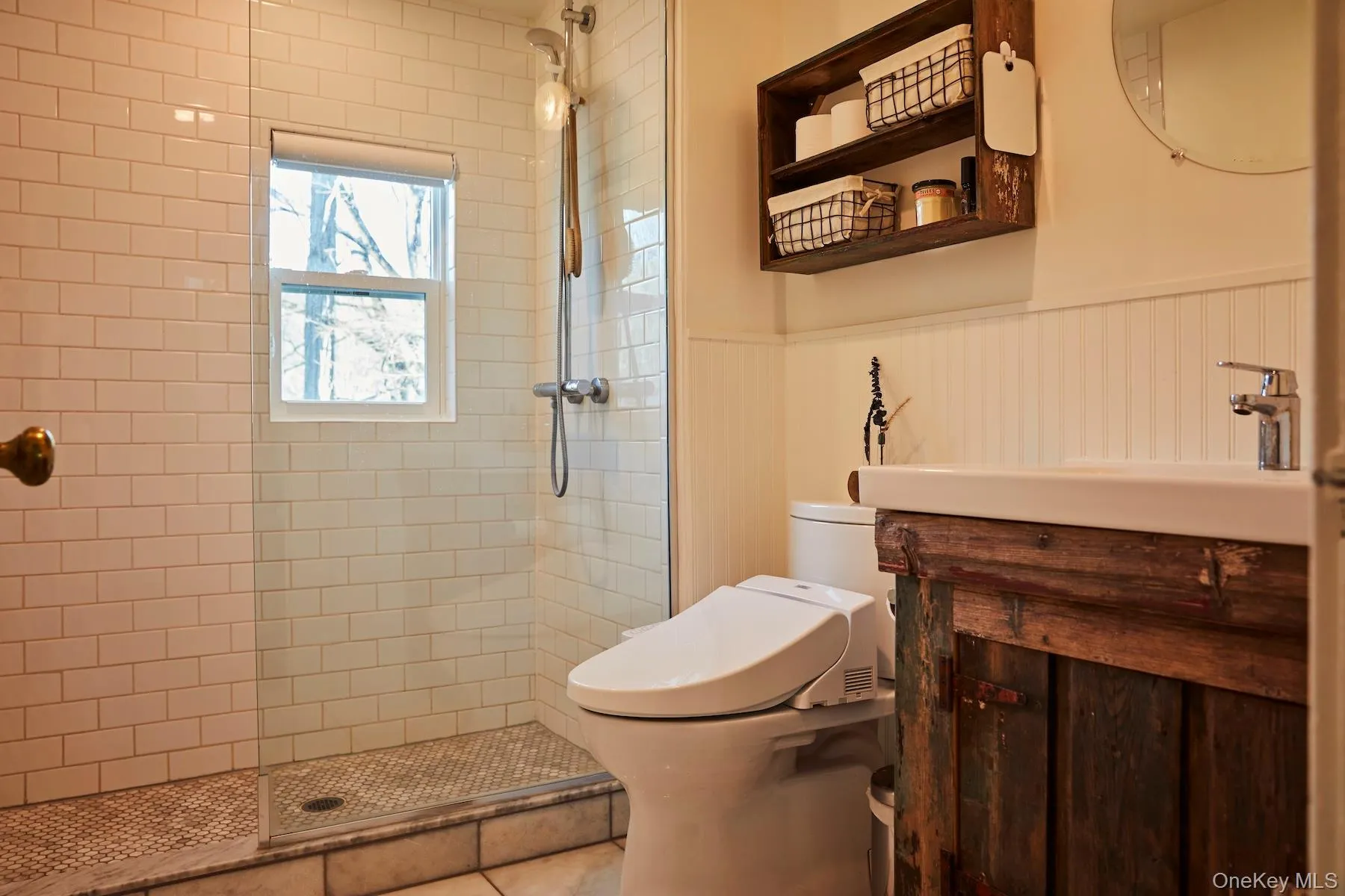 Bathroom with vanity, a walk in shower, a wainscoted wall, and tile patterned flooring Bathroom with vanity, a walk in shower, a wainscoted wall, and tile patterned flooring