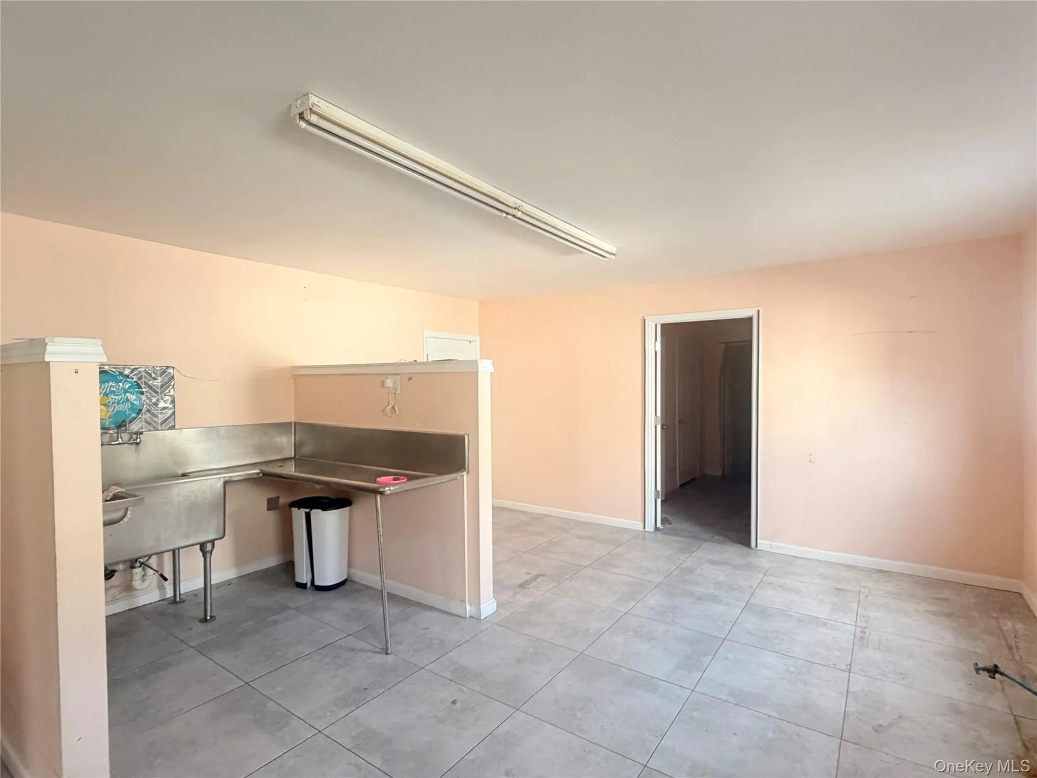 Unfurnished office with baseboards and light tile patterned floors Unfurnished office with baseboards and light tile patterned floors