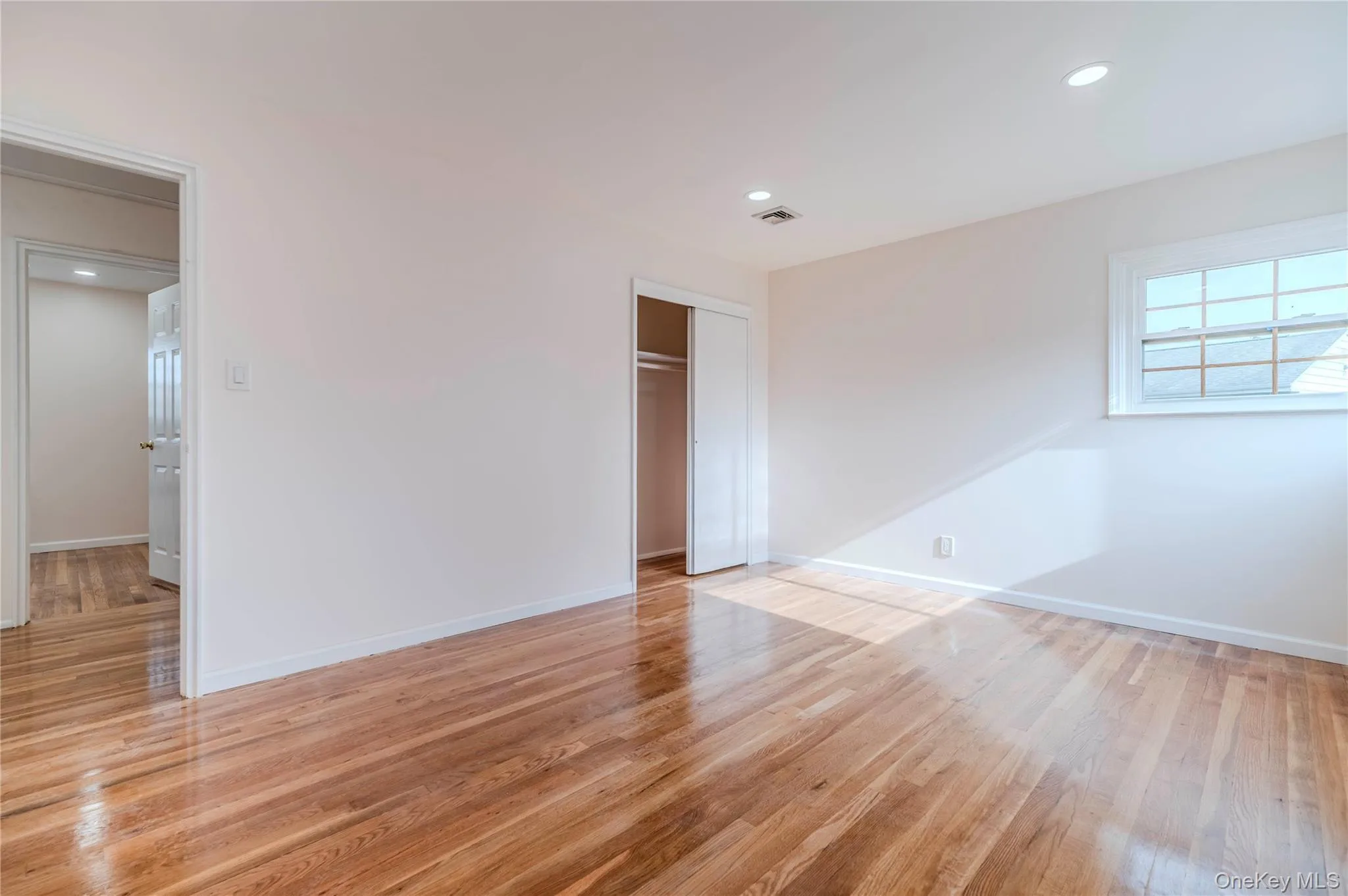 Unfurnished bedroom featuring light wood-style floors, recessed lighting, and a closet Unfurnished bedroom featuring light wood-style floors, recessed lighting, and a closet