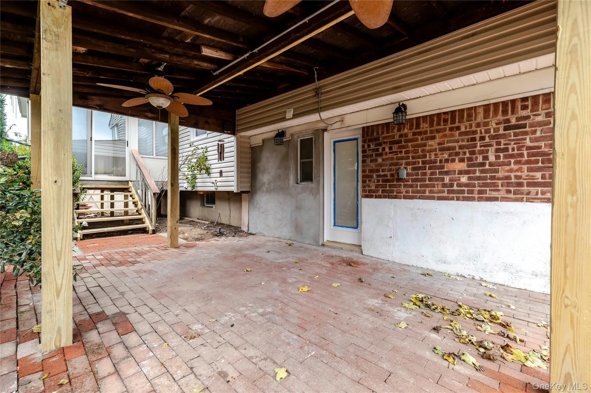 View of patio / terrace with a ceiling fan and stairway View of patio / terrace with a ceiling fan and stairway