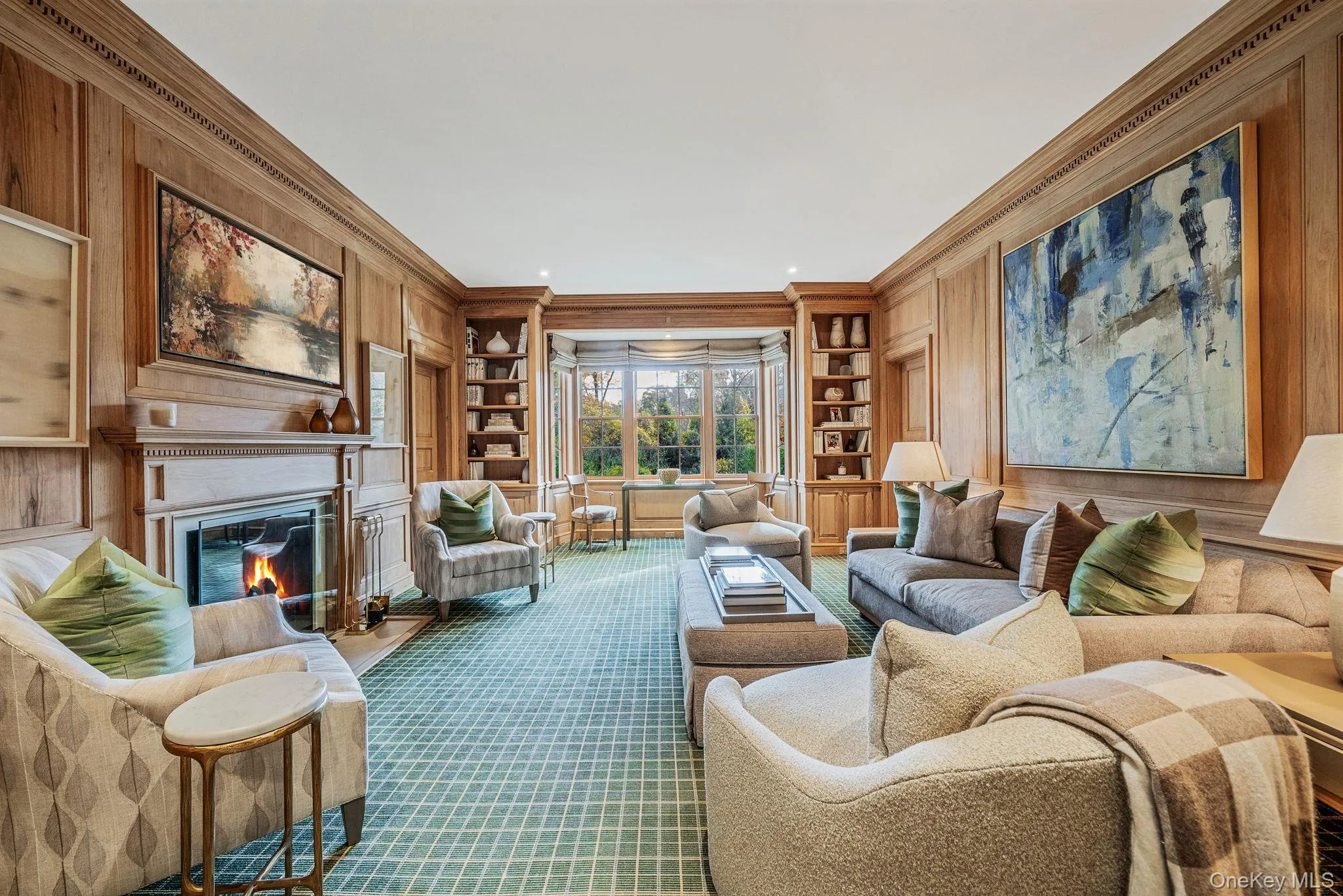 Library with built in shelves, a glass covered fireplace Library with built in shelves, a glass covered fireplace