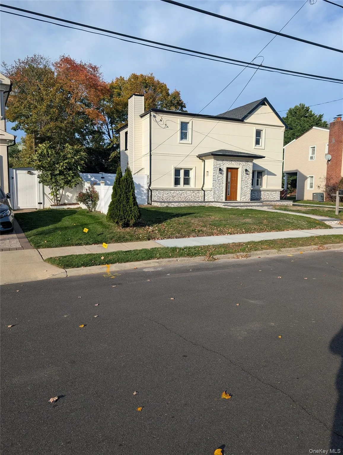 View of front facade featuring stone siding and a chimney View of front facade featuring stone siding and a chimney