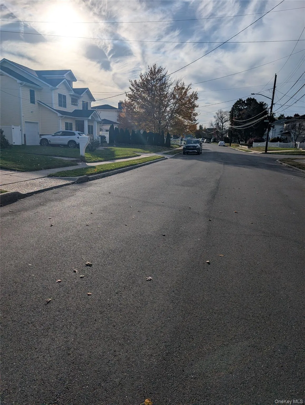 View of asphalt street with curbs, sidewalks, and a residential view View of asphalt street with curbs, sidewalks, and a residential view