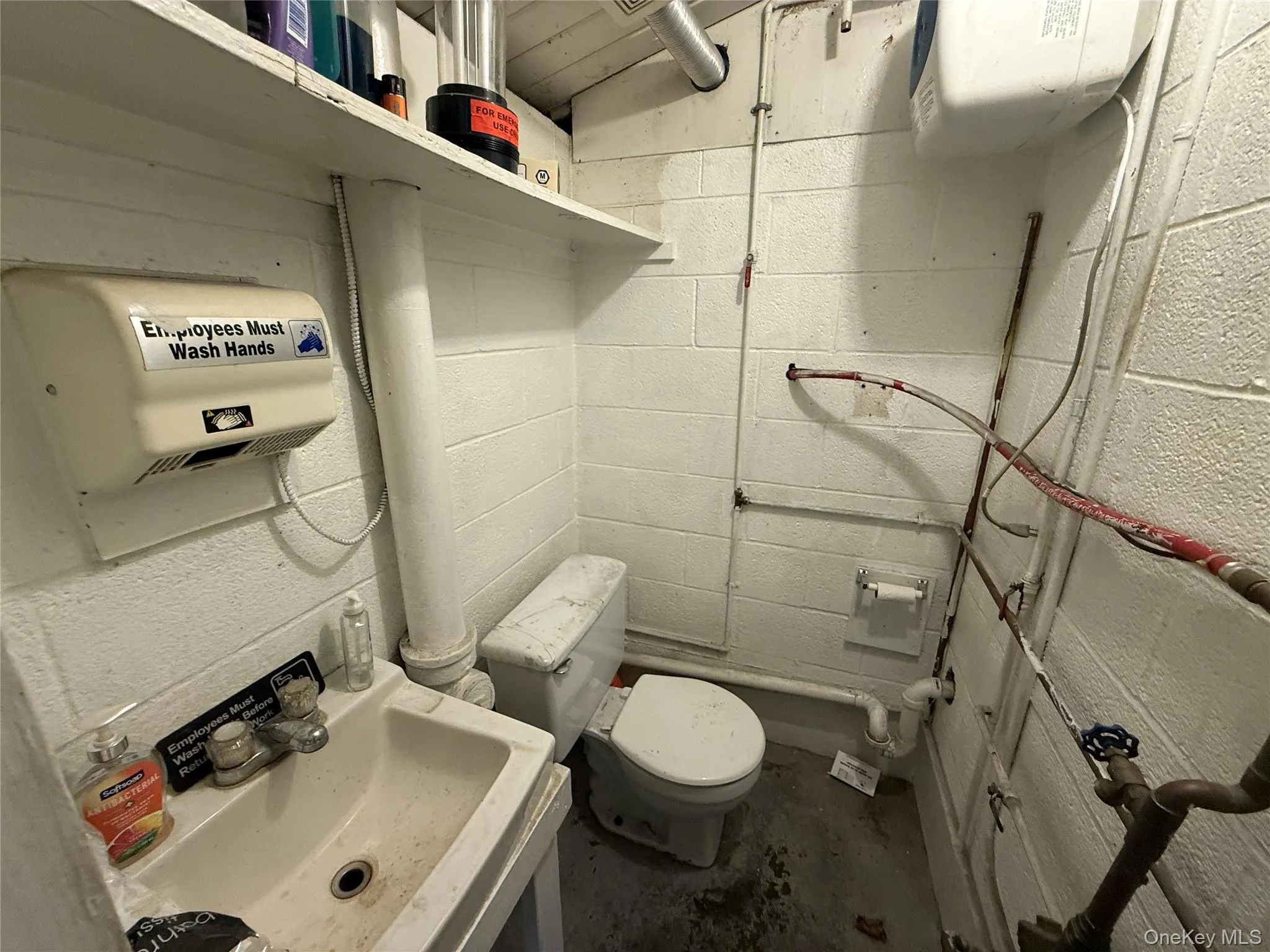 Bathroom featuring concrete flooring and vanity Bathroom featuring concrete flooring and vanity