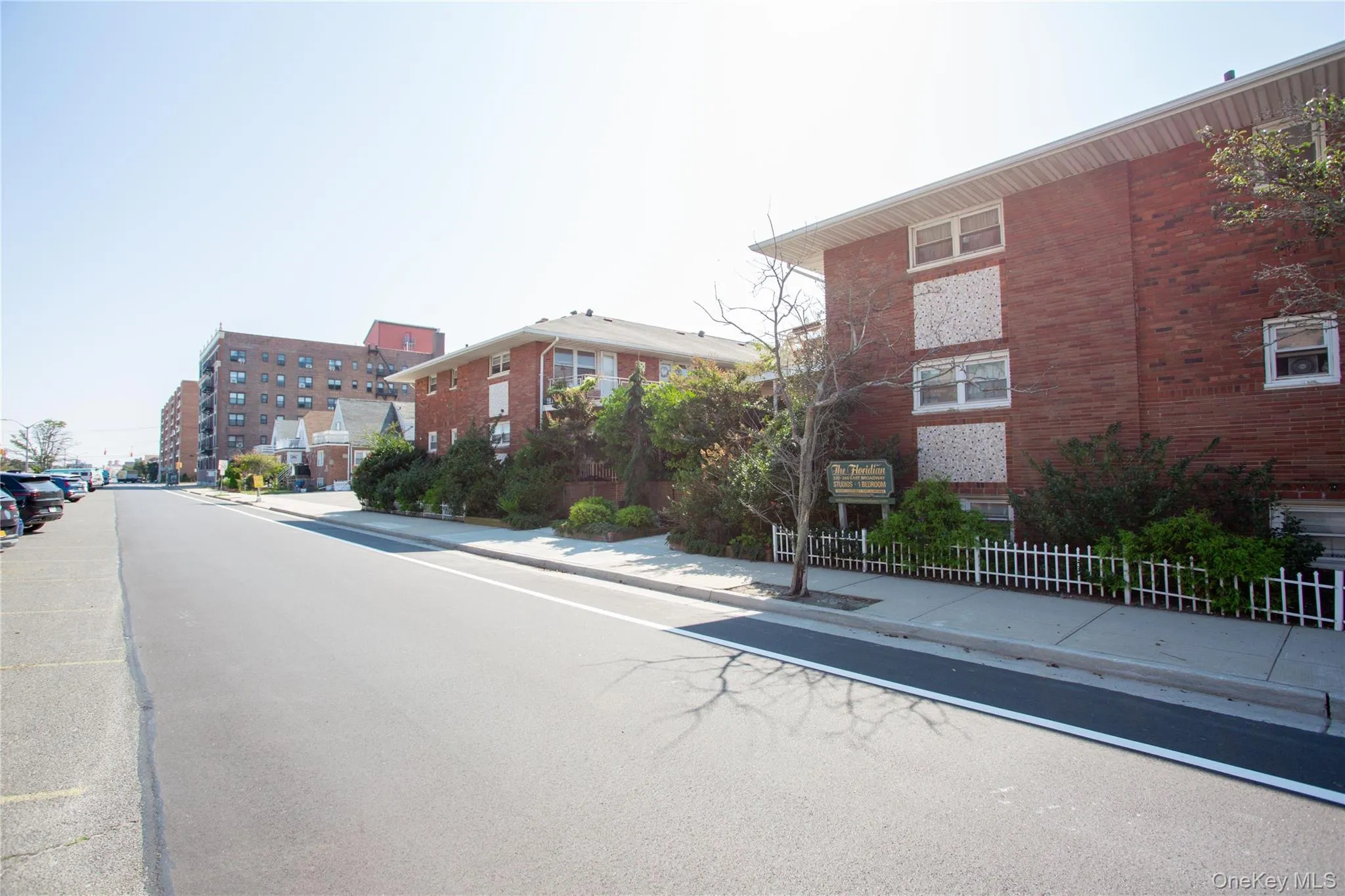 View of asphalt road with sidewalks and curbs View of asphalt road with sidewalks and curbs