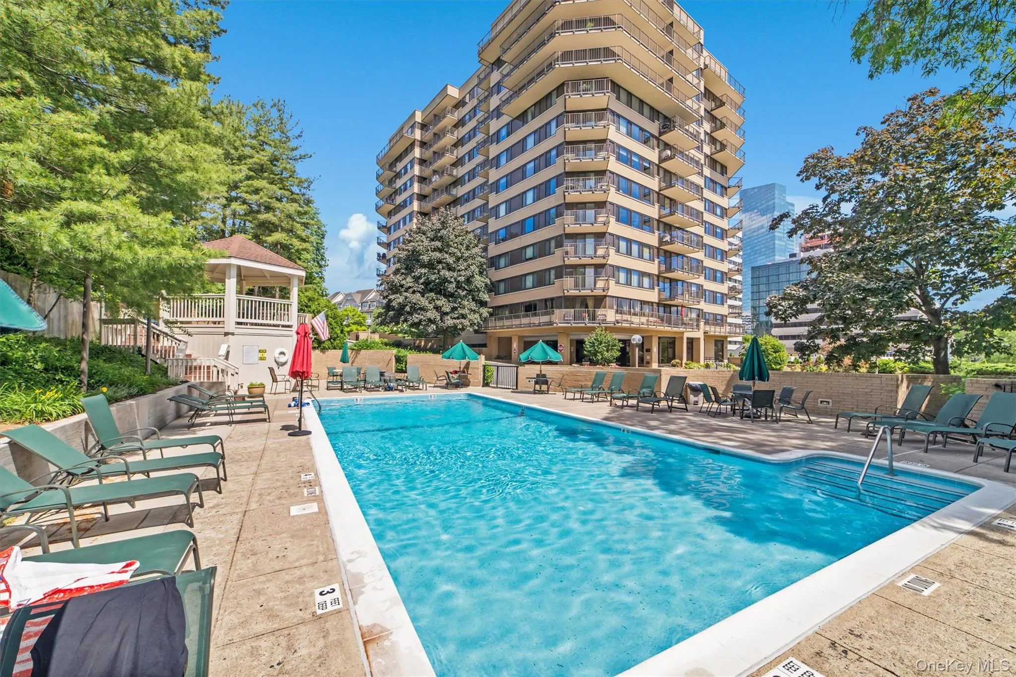 Community pool with a gazebo and a patio Community pool with a gazebo and a patio