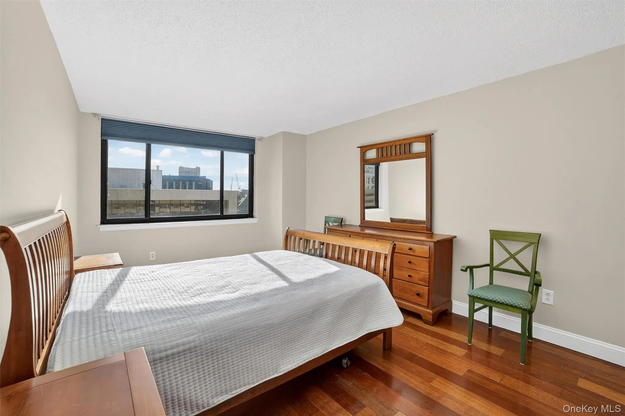 Bedroom featuring wood finished floors and a textured ceiling Bedroom featuring wood finished floors and a textured ceiling