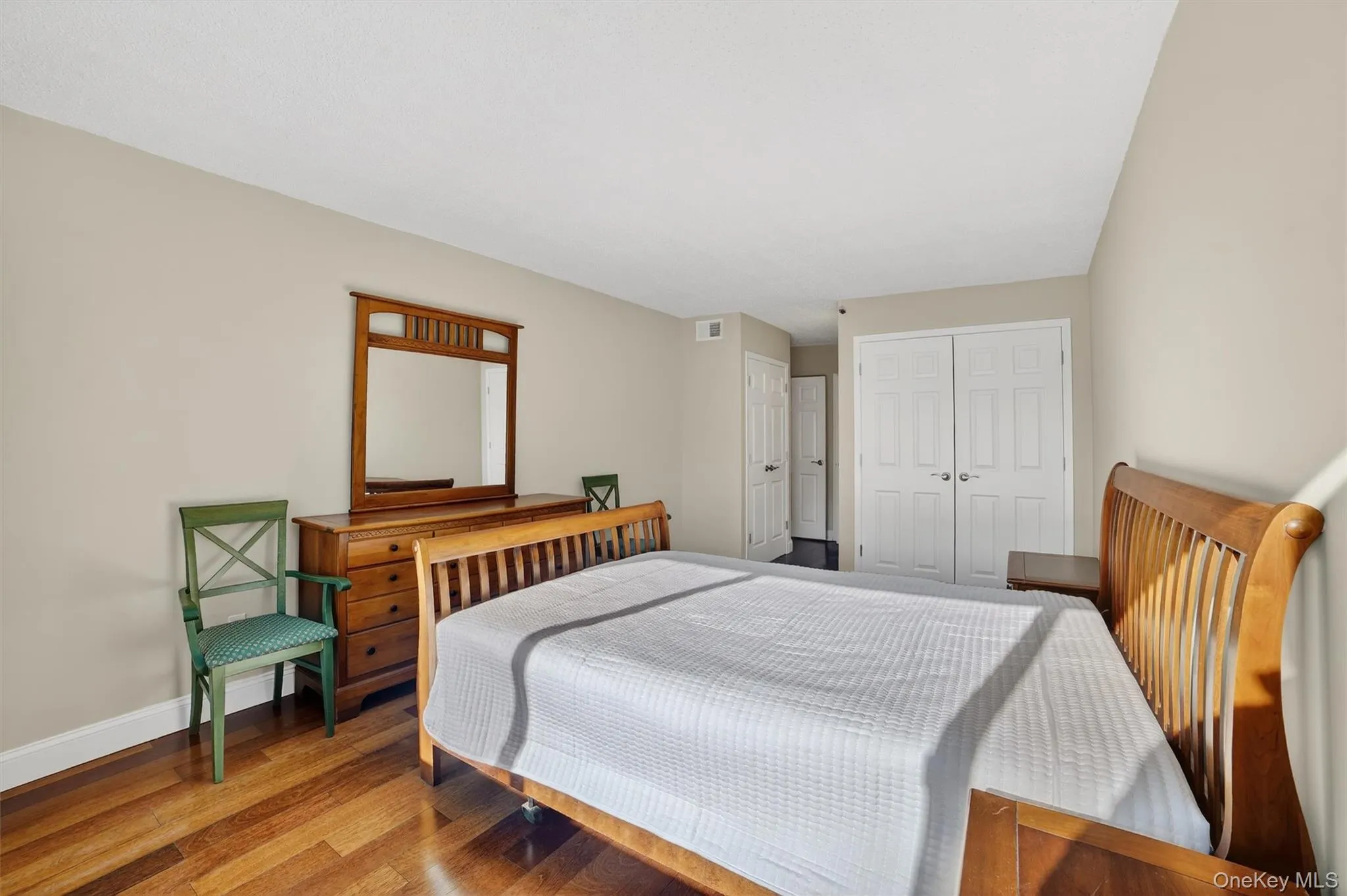 Bedroom with a closet and wood finished floors Bedroom with a closet and wood finished floors