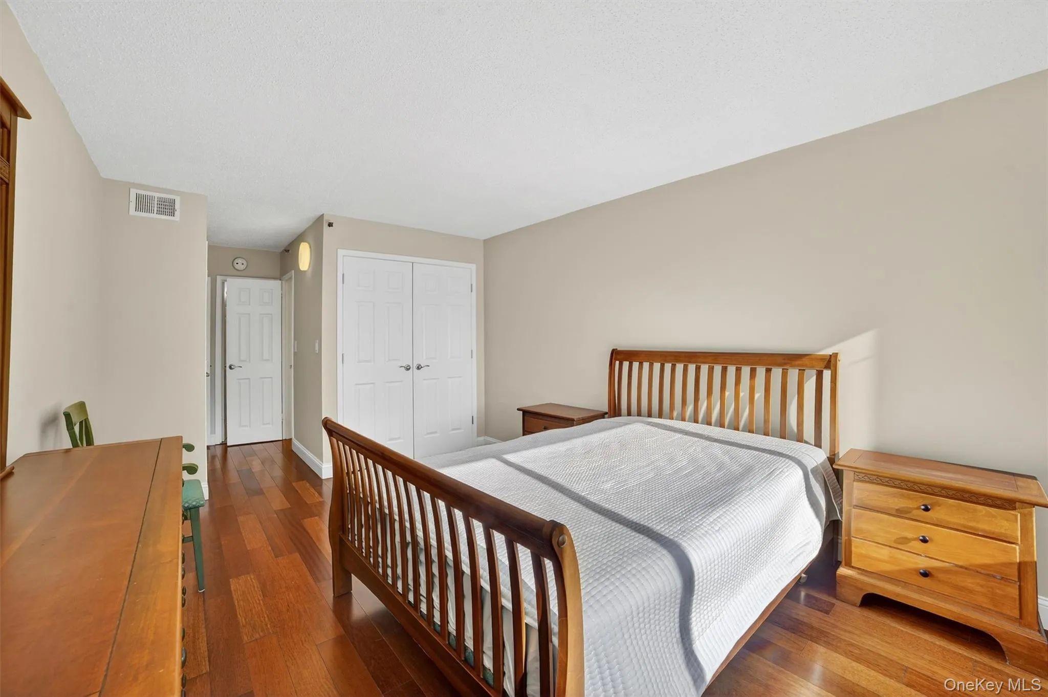 Bedroom featuring a closet and dark wood-style flooring Bedroom featuring a closet and dark wood-style flooring