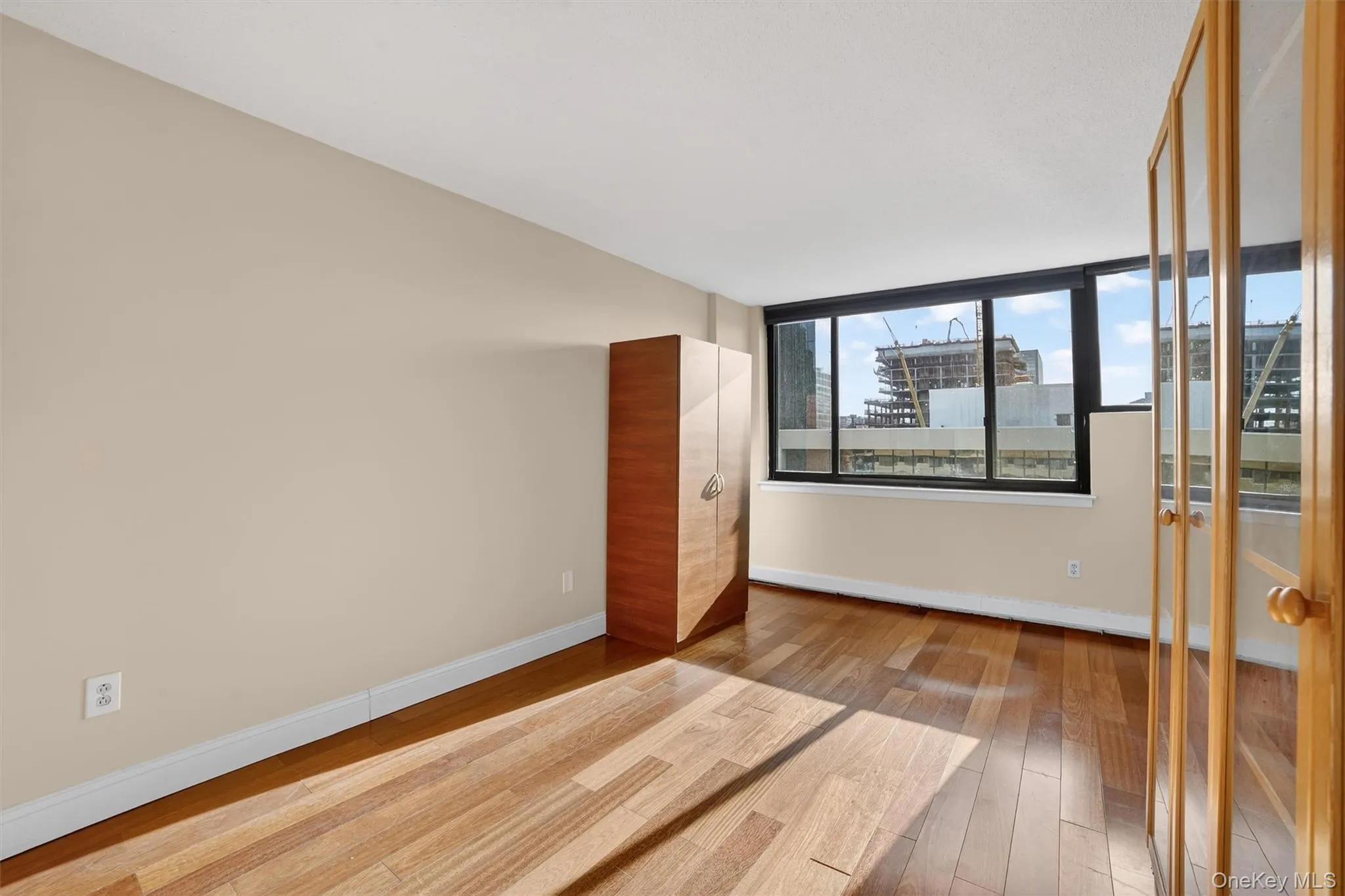 Empty room featuring light wood-type flooring and baseboards Empty room featuring light wood-type flooring and baseboards