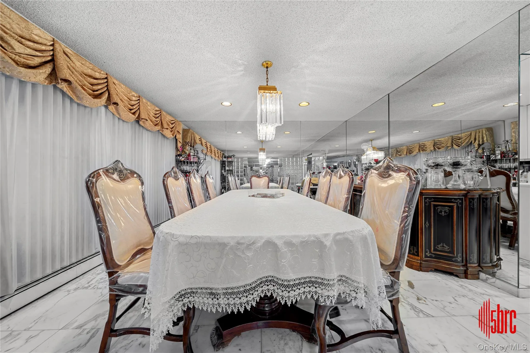Dining area featuring marble finish flooring, baseboard heating, a textured ceiling, and recessed lighting Dining area featuring marble finish flooring, baseboard heating, a textured ceiling, and recessed lighting