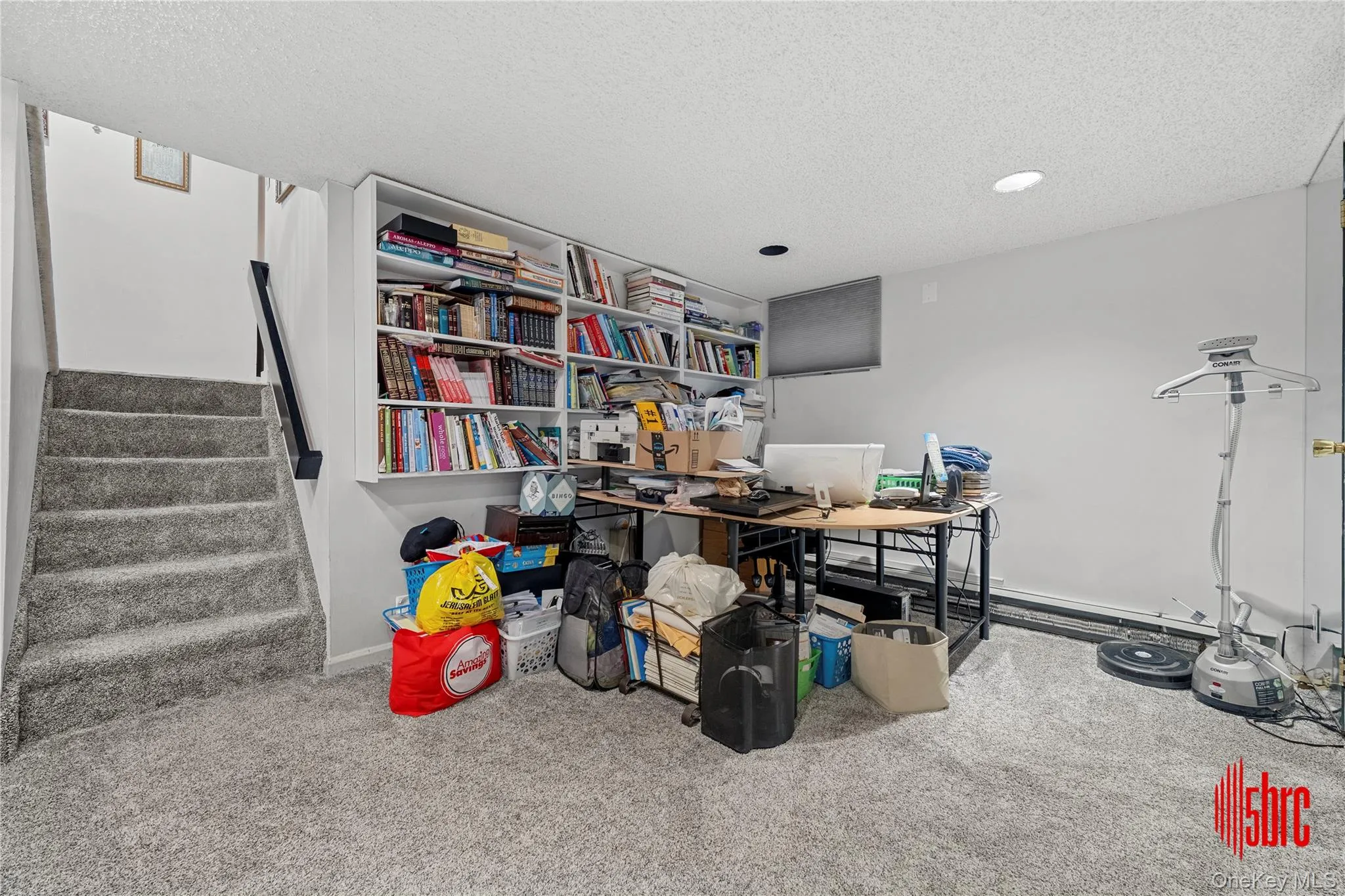 Carpeted home office featuring a textured ceiling and baseboards Carpeted home office featuring a textured ceiling and baseboards