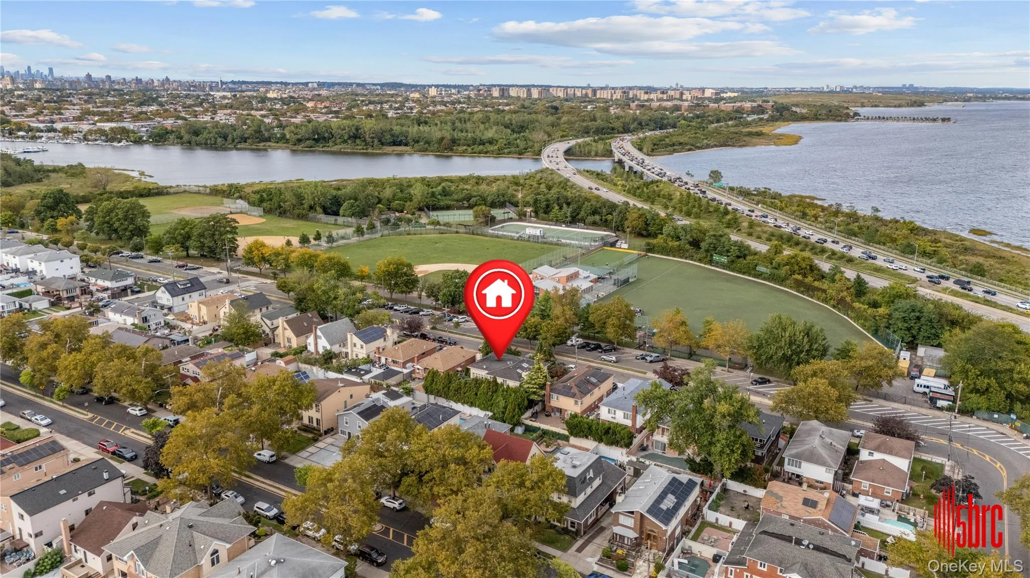 Aerial view of property's location with a notable bridge, nearby suburban area, and a nearby body of water Aerial view of property's location with a notable bridge, nearby suburban area, and a nearby body of water