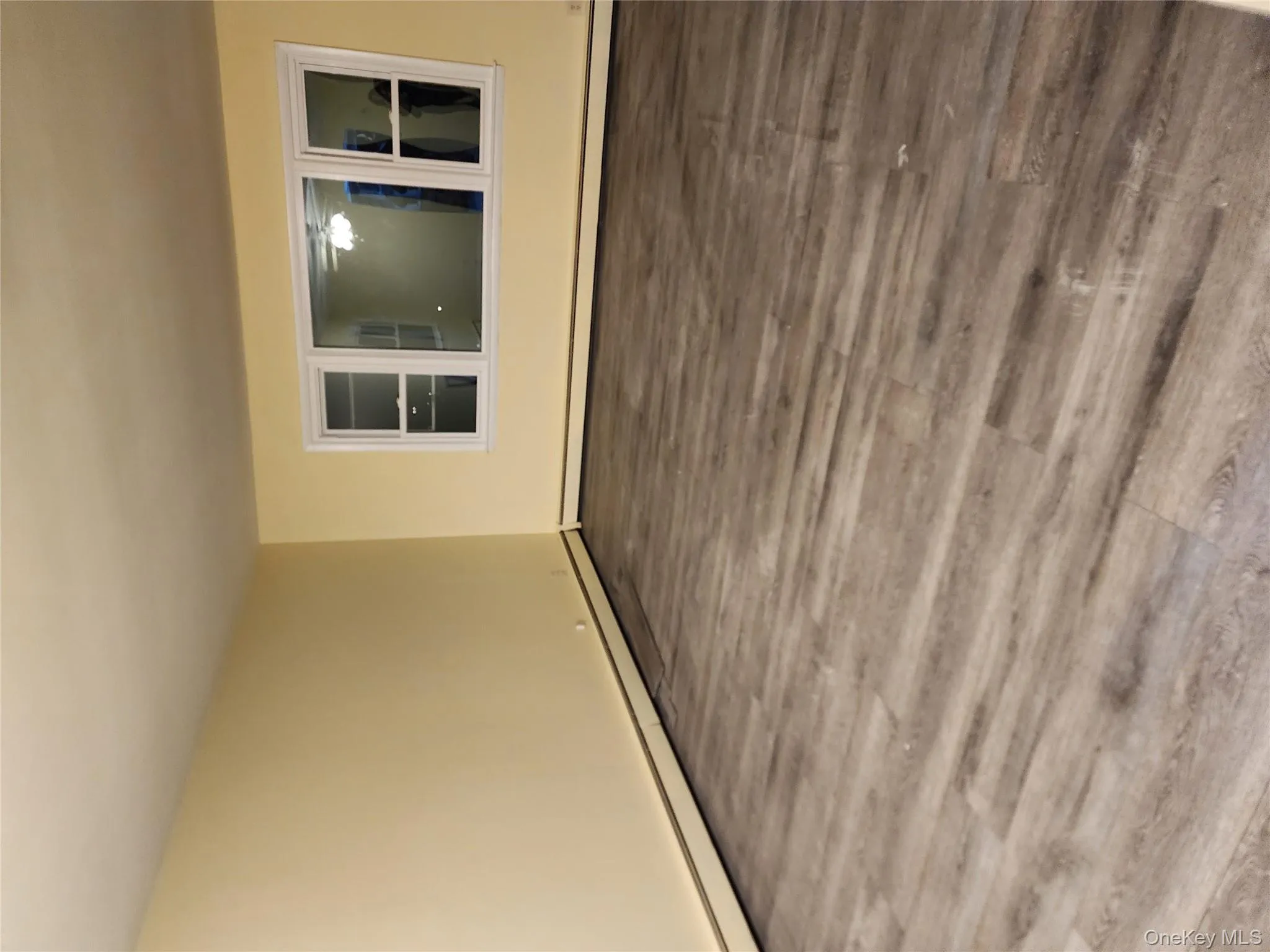 Empty room featuring wood finished floors and baseboard heating Empty room featuring wood finished floors and baseboard heating