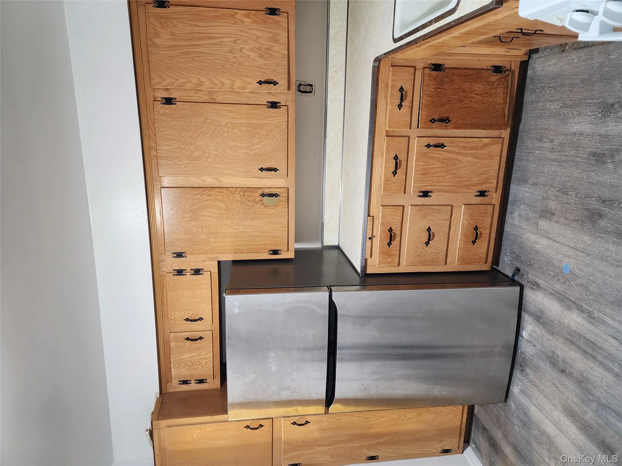 Kitchen with stainless steel fridge, light countertops, dark wood-type flooring, and range Kitchen with stainless steel fridge, light countertops, dark wood-type flooring, and range