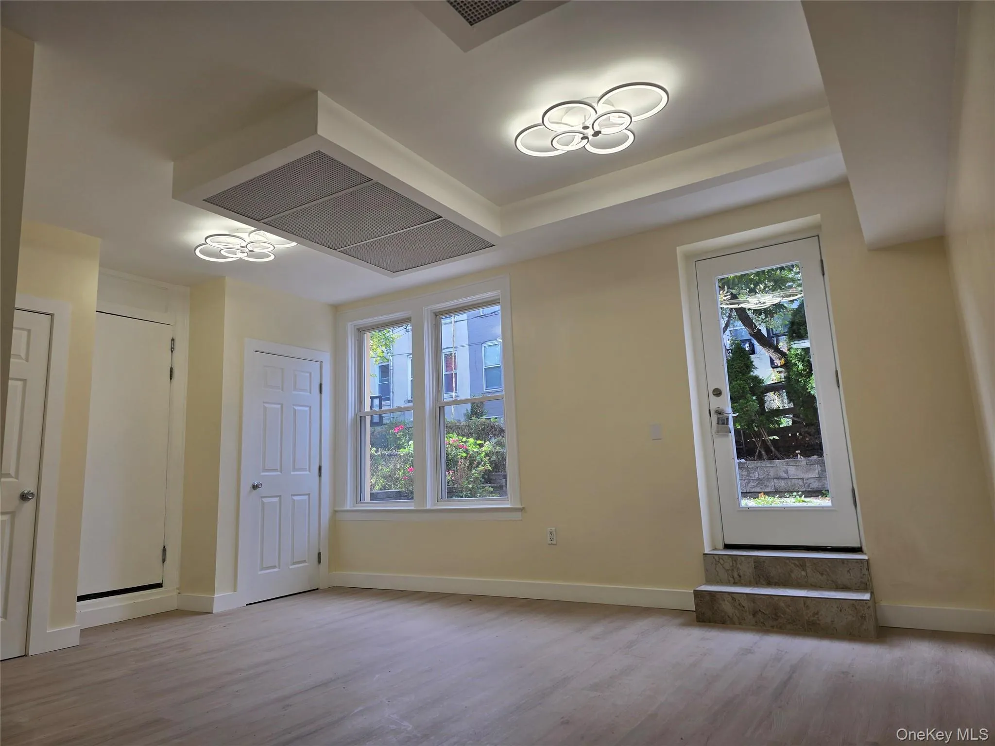 Living room featuring plenty of natural light and light wood-style flooring with access to outdoor space. Living room featuring plenty of natural light and light wood-style flooring with access to outdoor space.
