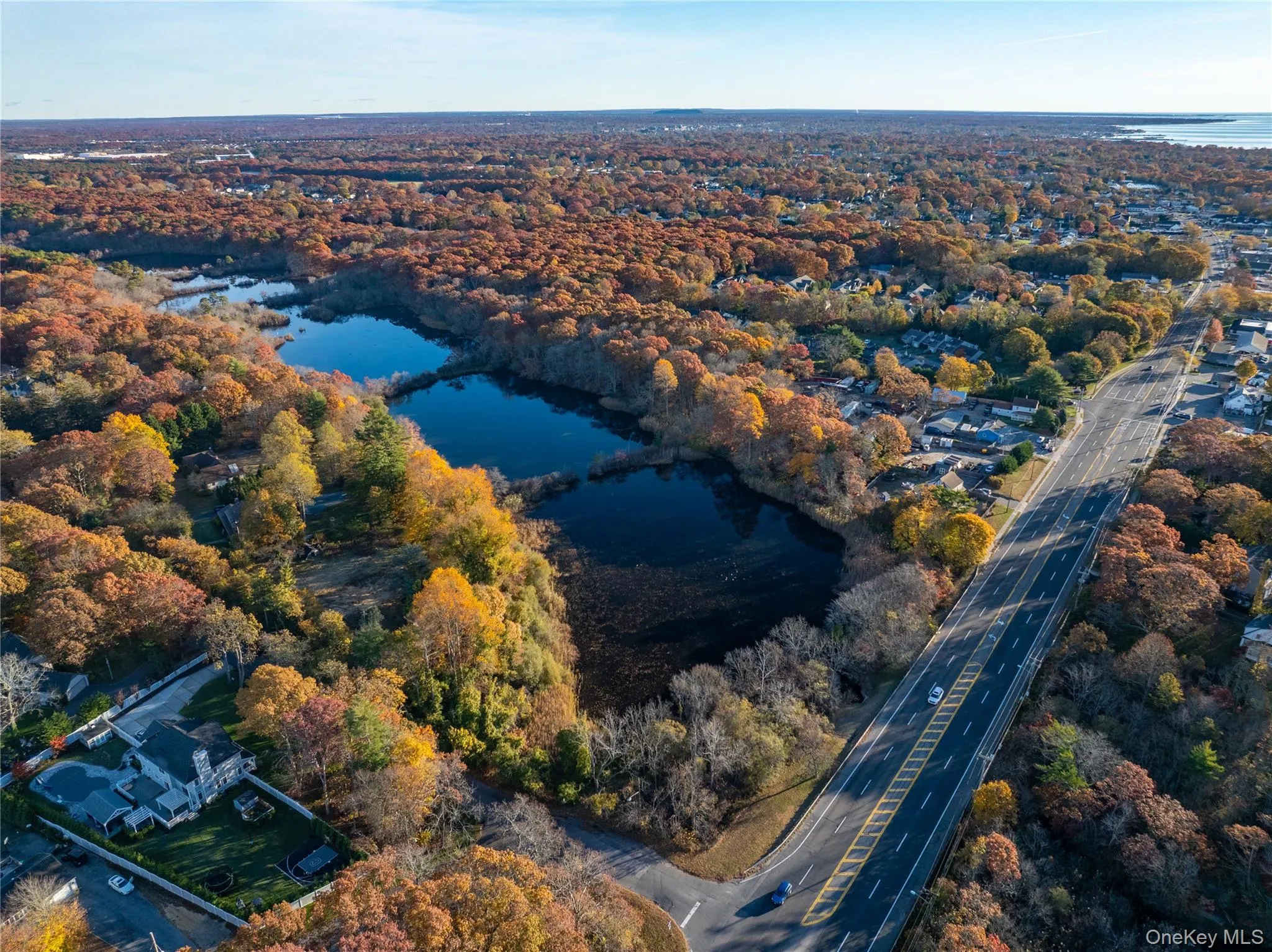 Aerial view of property and surrounding area featuring a nearby body of water Aerial view of property and surrounding area featuring a nearby body of water