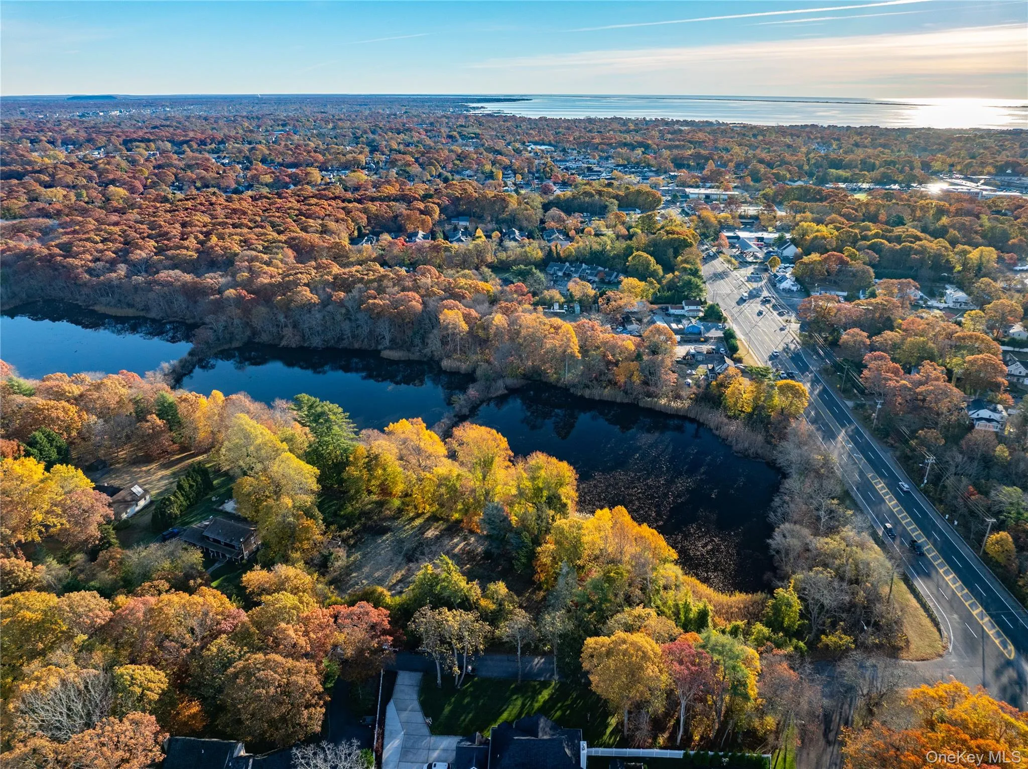 Aerial view of property's location featuring a large body of water Aerial view of property's location featuring a large body of water