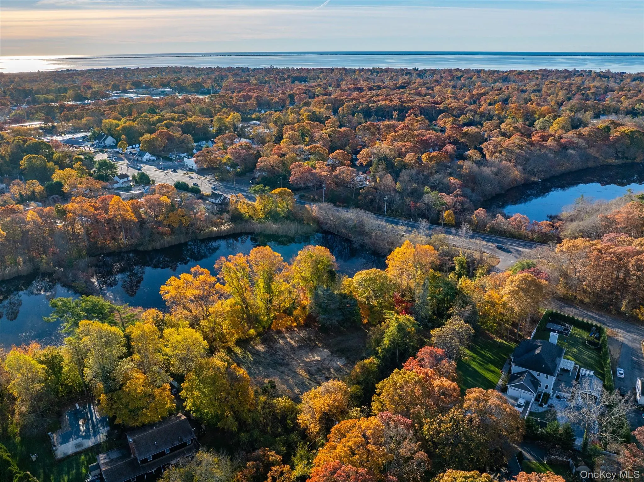 Drone / aerial view of a large body of water and a heavily wooded area Drone / aerial view of a large body of water and a heavily wooded area