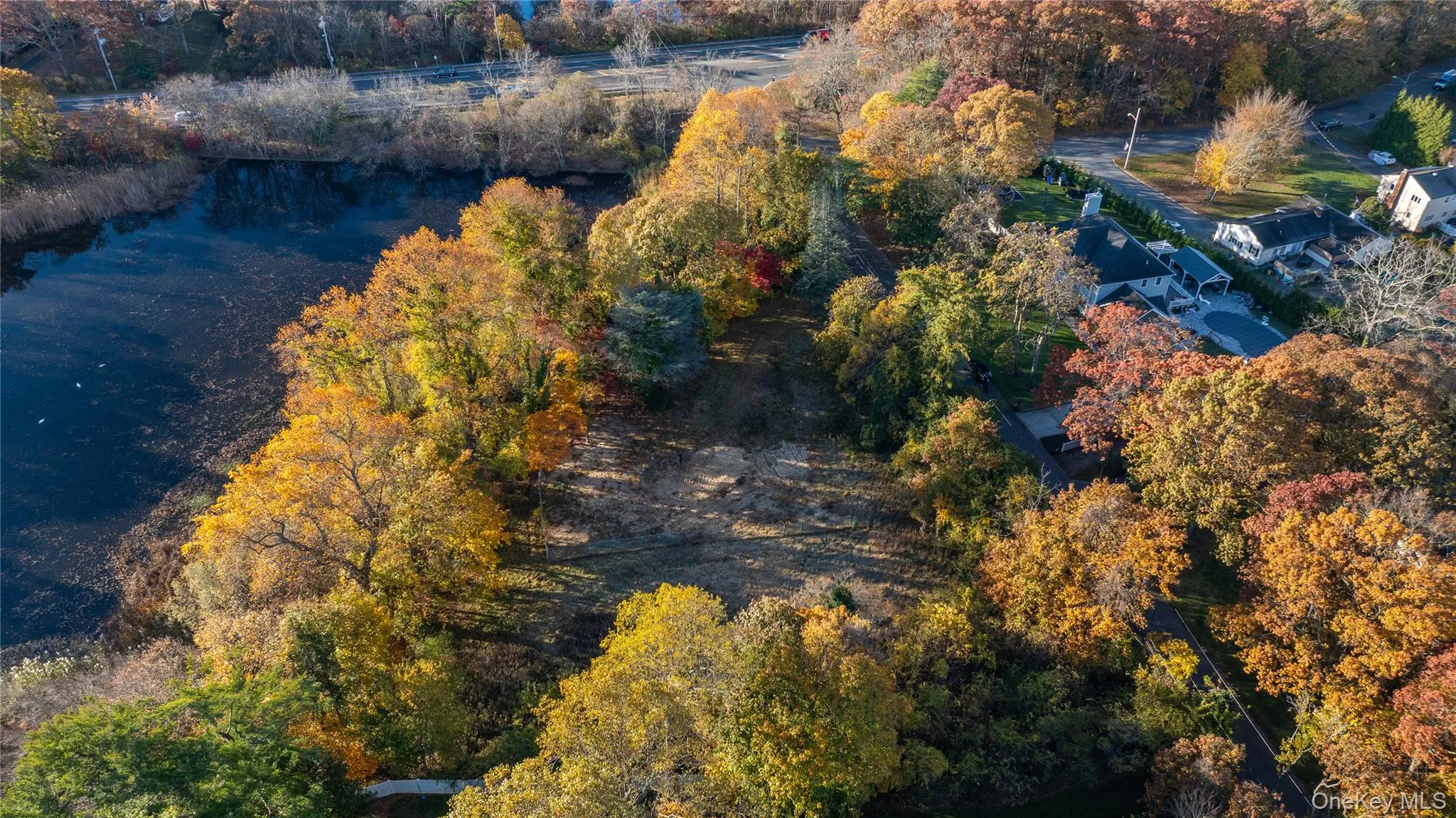 Aerial view of a nearby body of water and a tree filled landscape Aerial view of a nearby body of water and a tree filled landscape