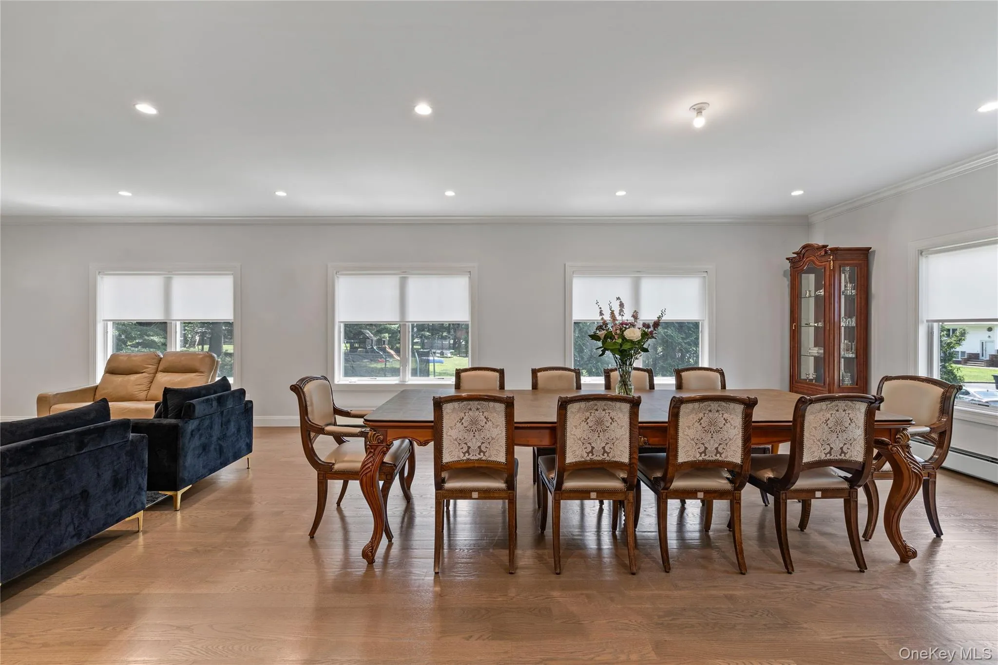 Dining room featuring ornamental molding, light wood-style flooring, recessed lighting, and healthy amount of natural light Dining room featuring ornamental molding, light wood-style flooring, recessed lighting, and healthy amount of natural light