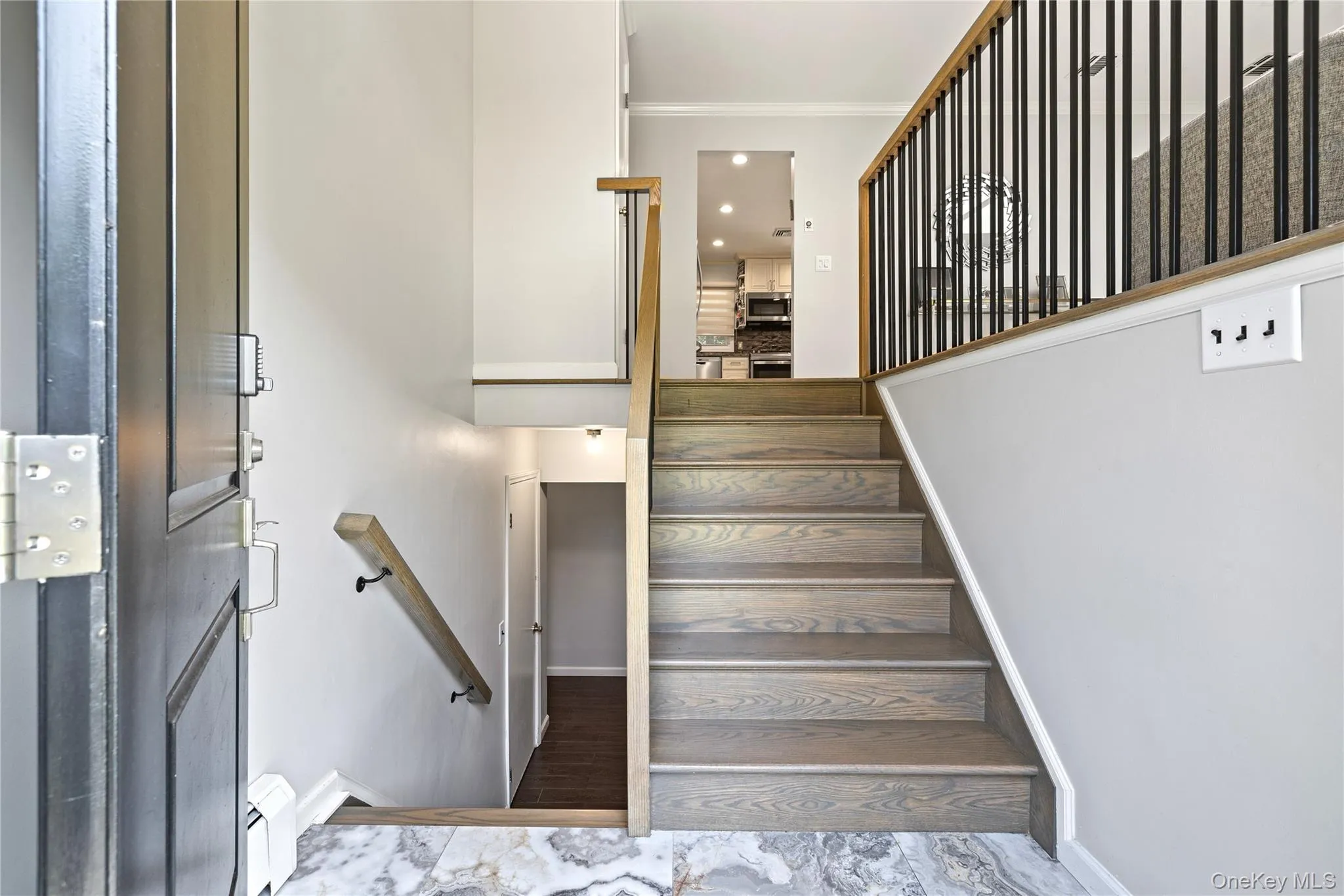 Stairs featuring crown molding, a baseboard heating unit, wood finished floors, and recessed lighting Stairs featuring crown molding, a baseboard heating unit, wood finished floors, and recessed lighting