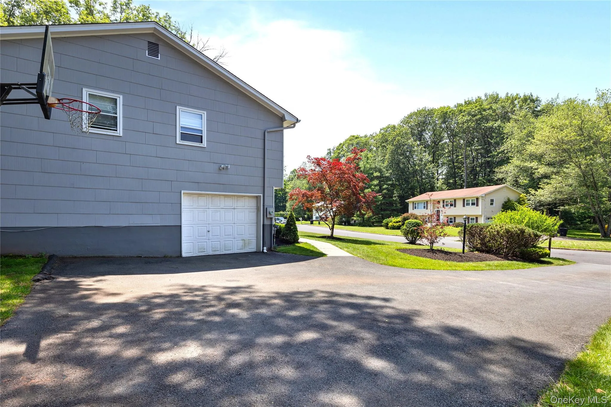 View of home's exterior featuring asphalt driveway and an attached garage View of home's exterior featuring asphalt driveway and an attached garage