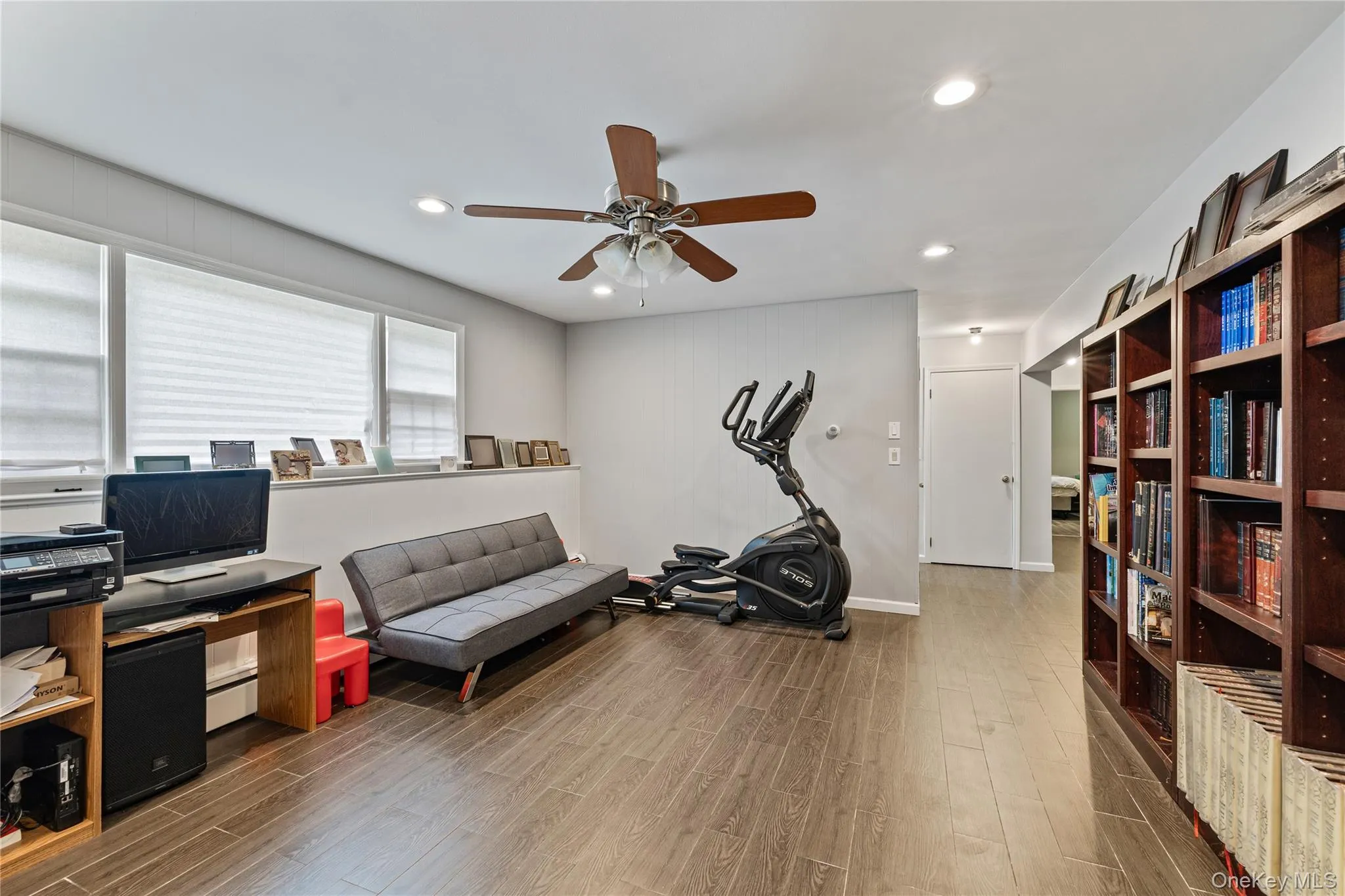 Home office with wood finish floors, recessed lighting, a baseboard radiator, and a ceiling fan Home office with wood finish floors, recessed lighting, a baseboard radiator, and a ceiling fan
