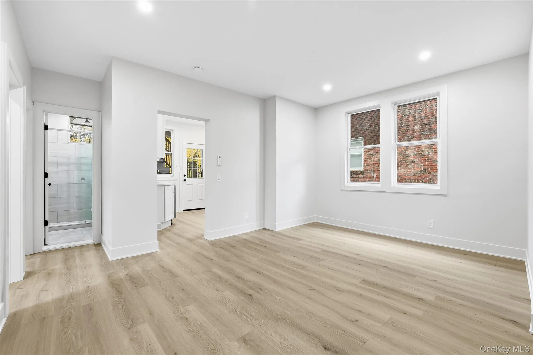 Empty room with light wood-style floors and recessed lighting Empty room with light wood-style floors and recessed lighting