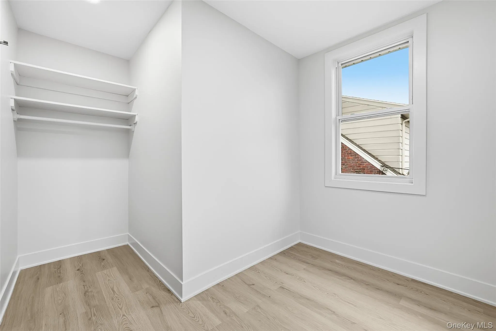 Unfurnished bedroom featuring baseboards and light wood finished floors Unfurnished bedroom featuring baseboards and light wood finished floors