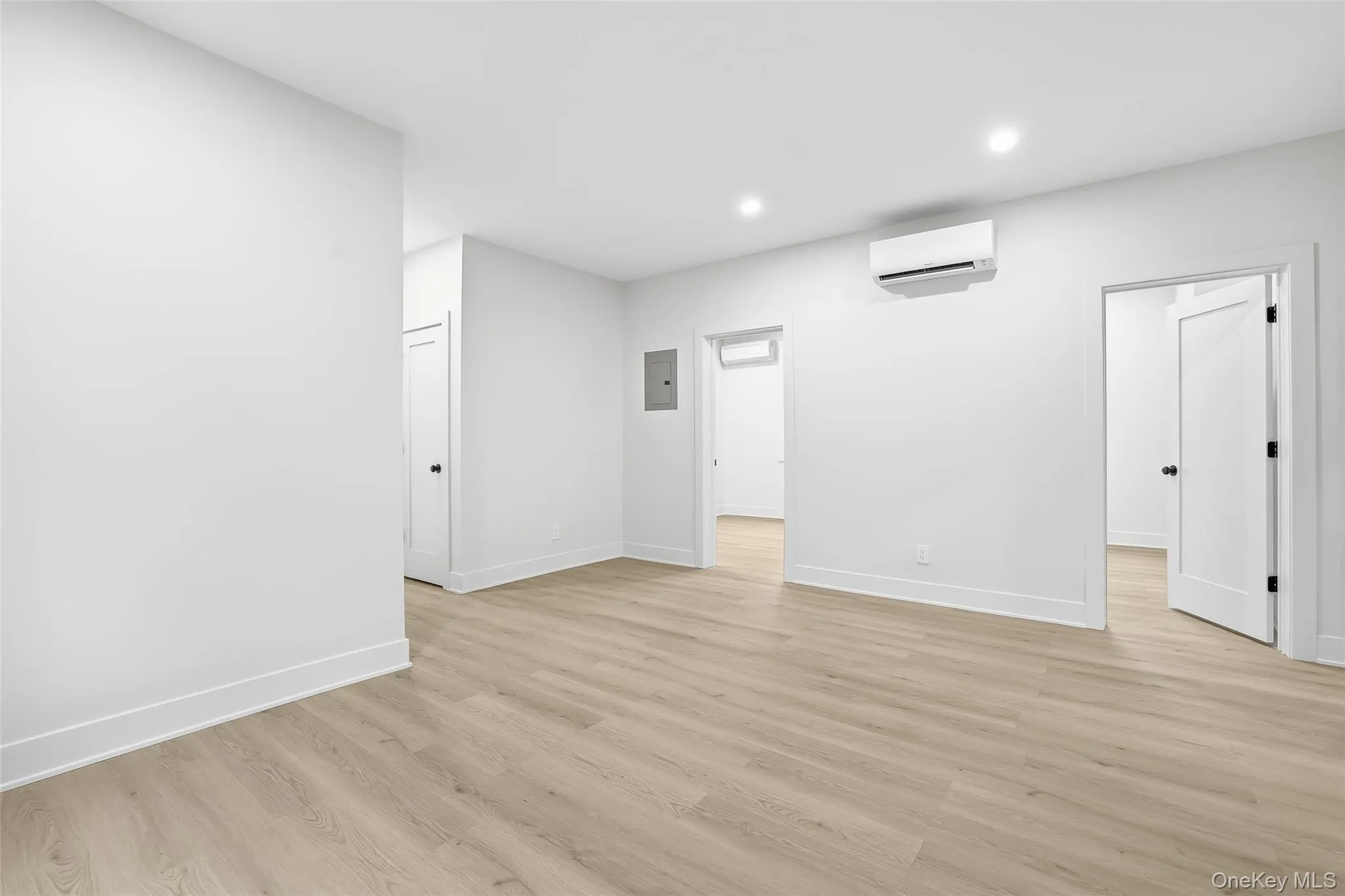 Spare room featuring light wood-style floors, recessed lighting, and electric panel Spare room featuring light wood-style floors, recessed lighting, and electric panel