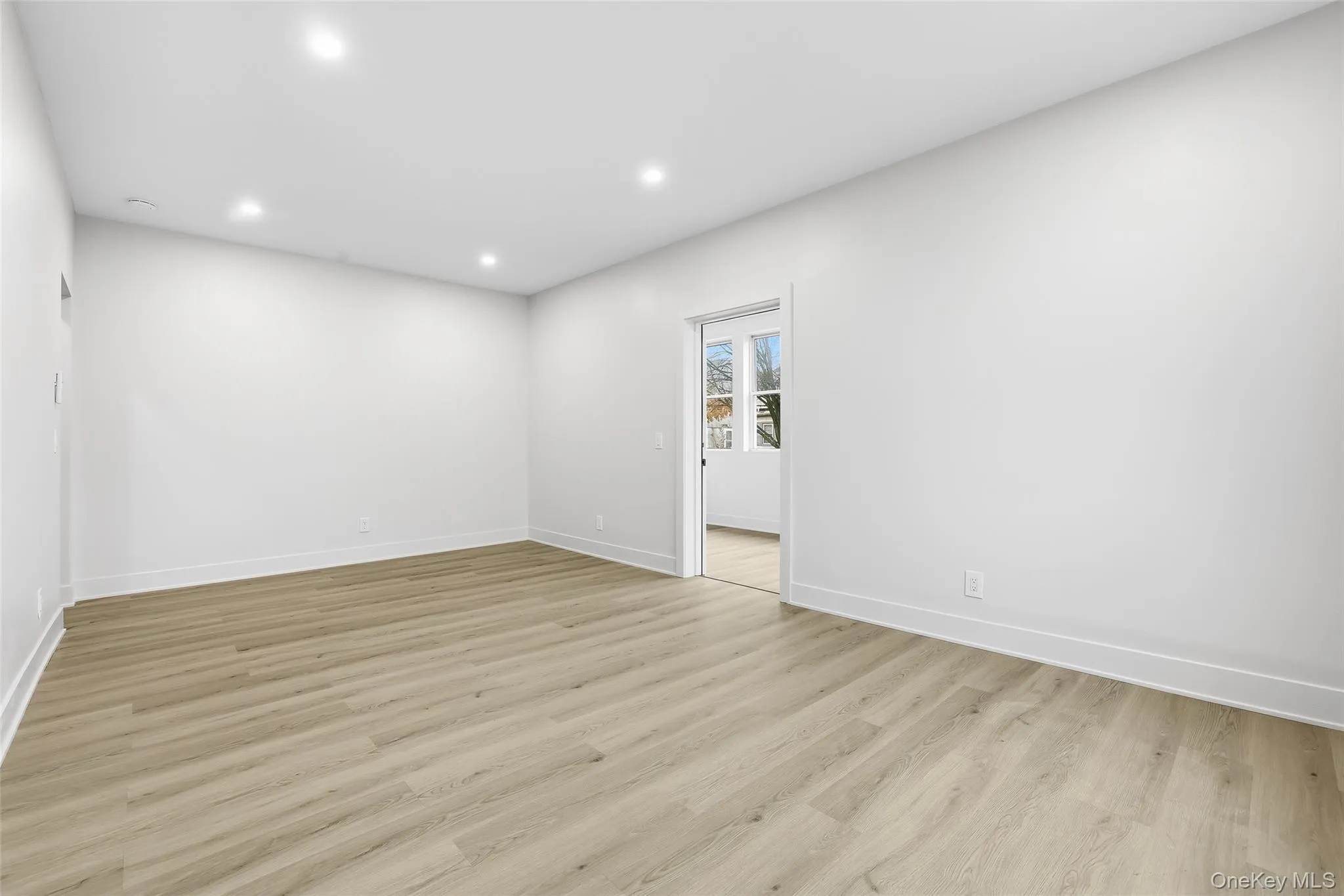 Empty room with light wood-type flooring and recessed lighting Empty room with light wood-type flooring and recessed lighting