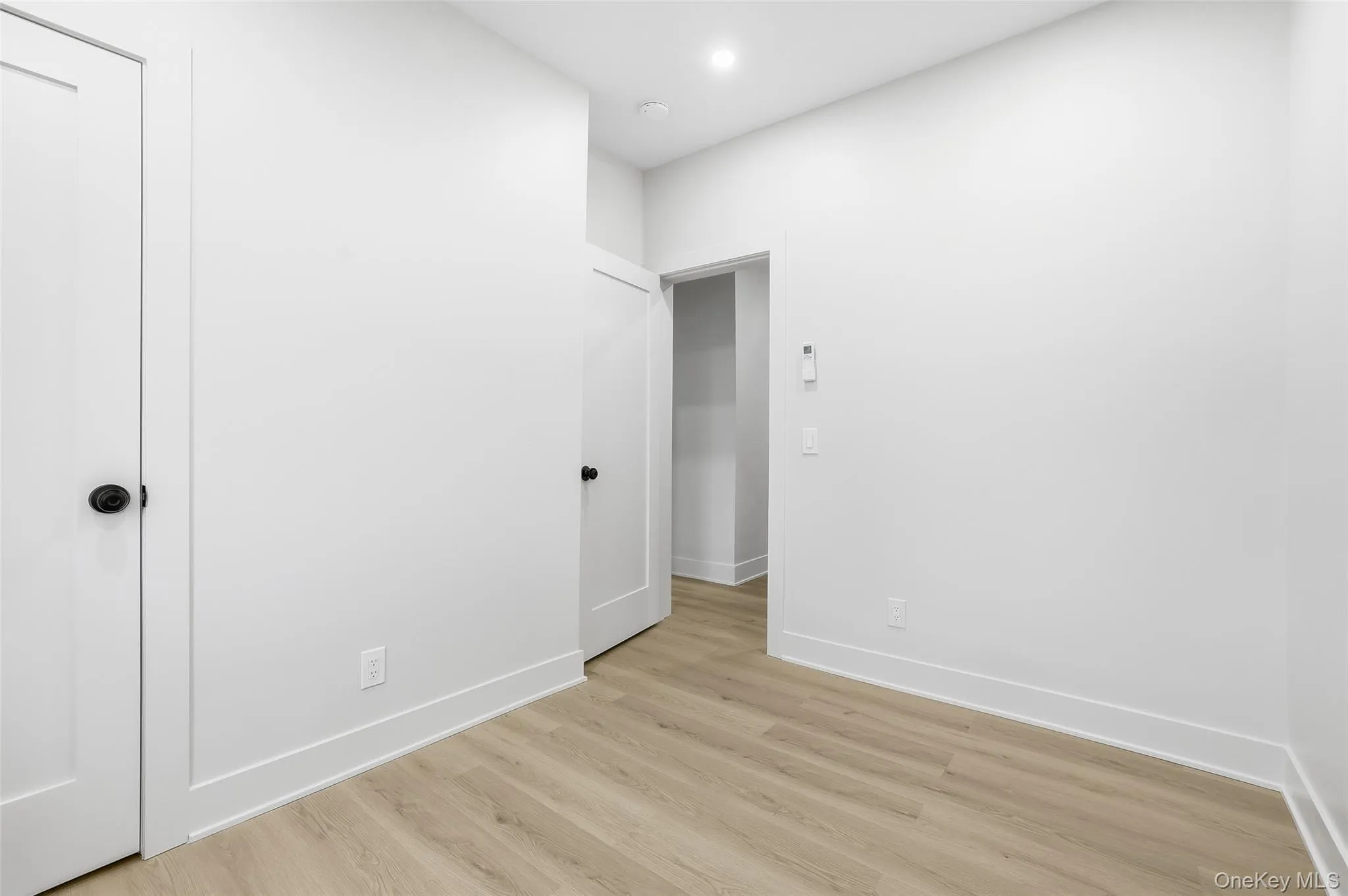 Unfurnished room with wood finished floors and recessed lighting Unfurnished room with wood finished floors and recessed lighting