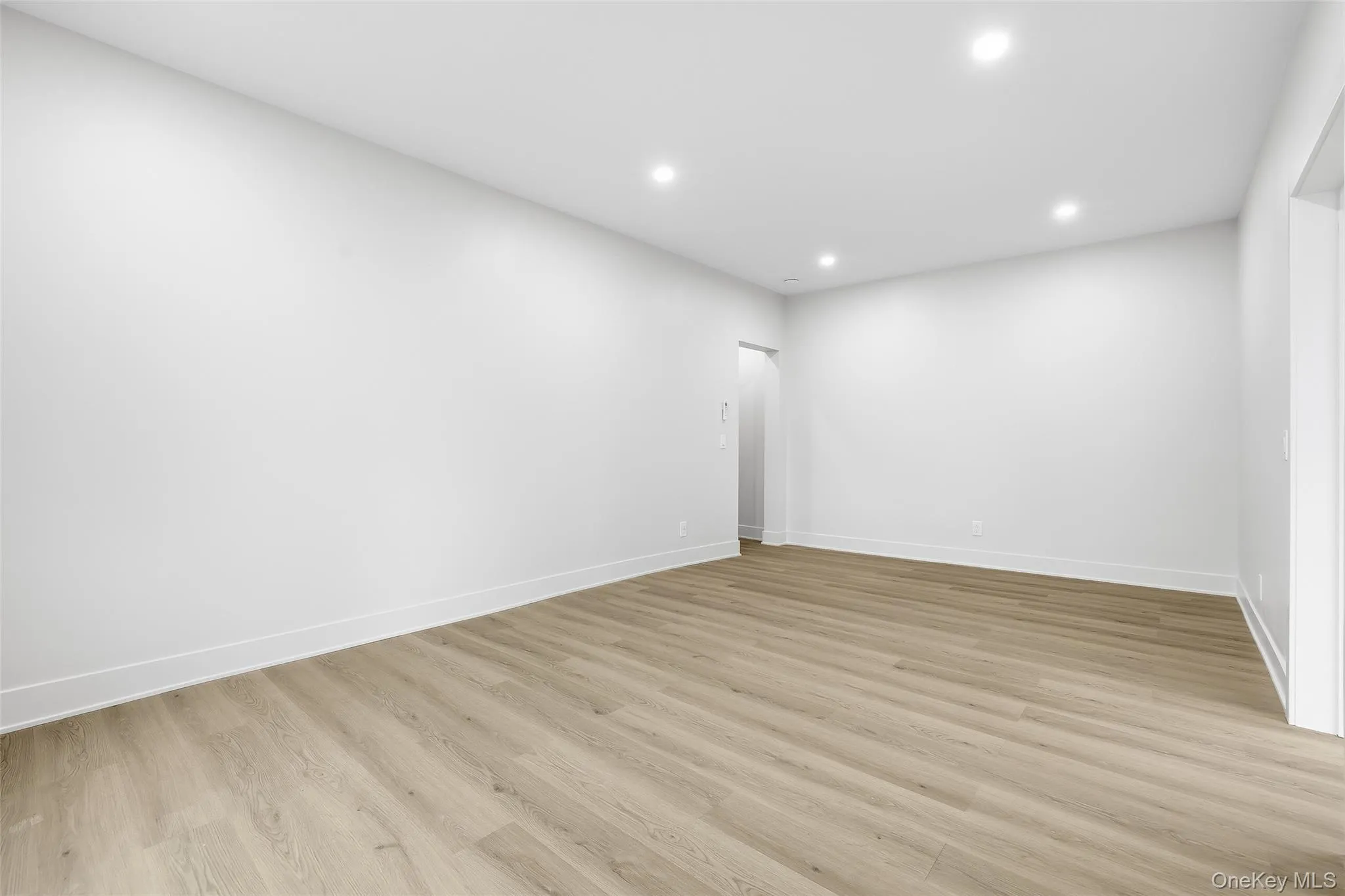 Unfurnished room with recessed lighting and light wood-style floors Unfurnished room with recessed lighting and light wood-style floors