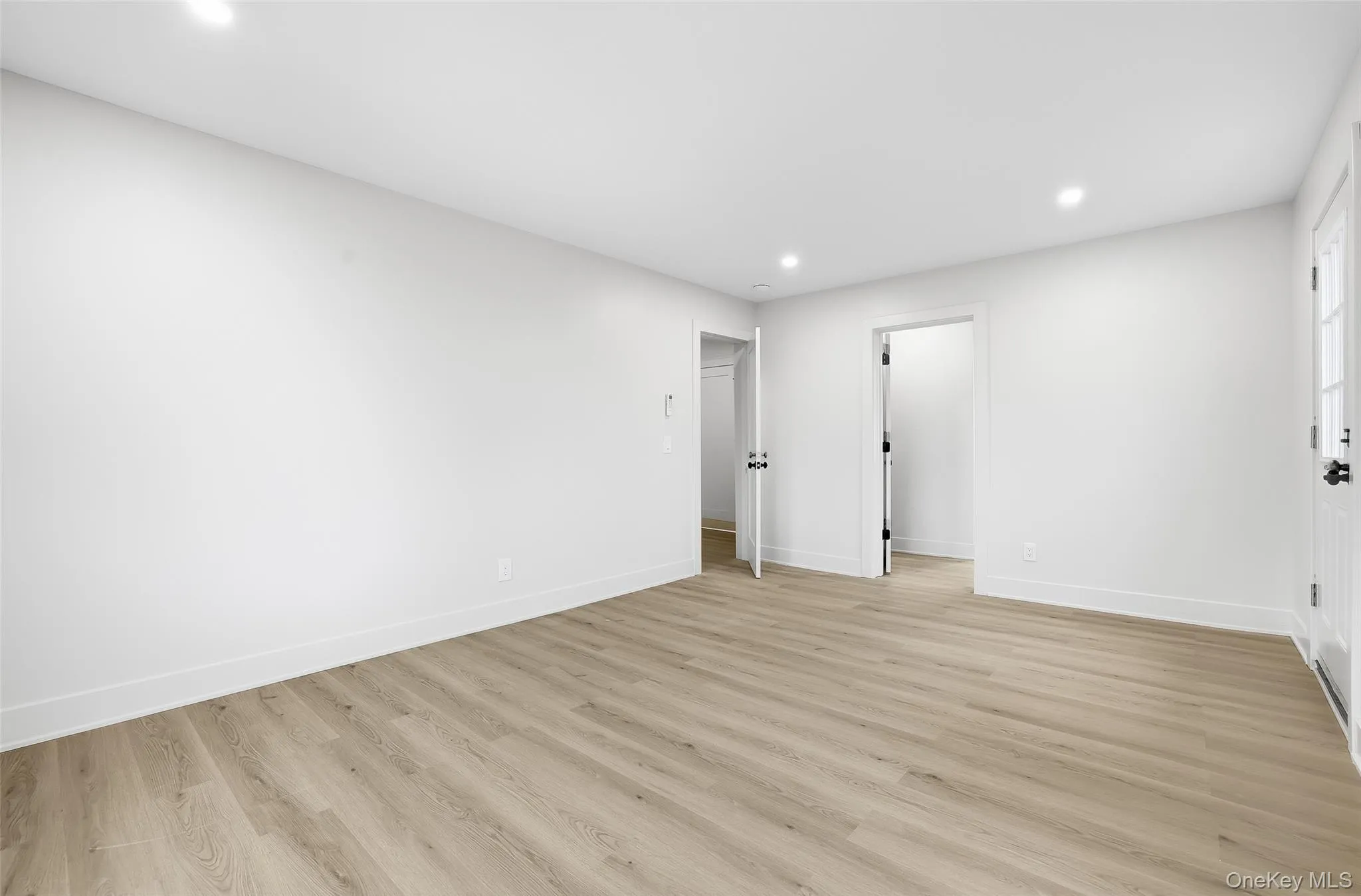Empty room featuring recessed lighting and light wood finished floors Empty room featuring recessed lighting and light wood finished floors