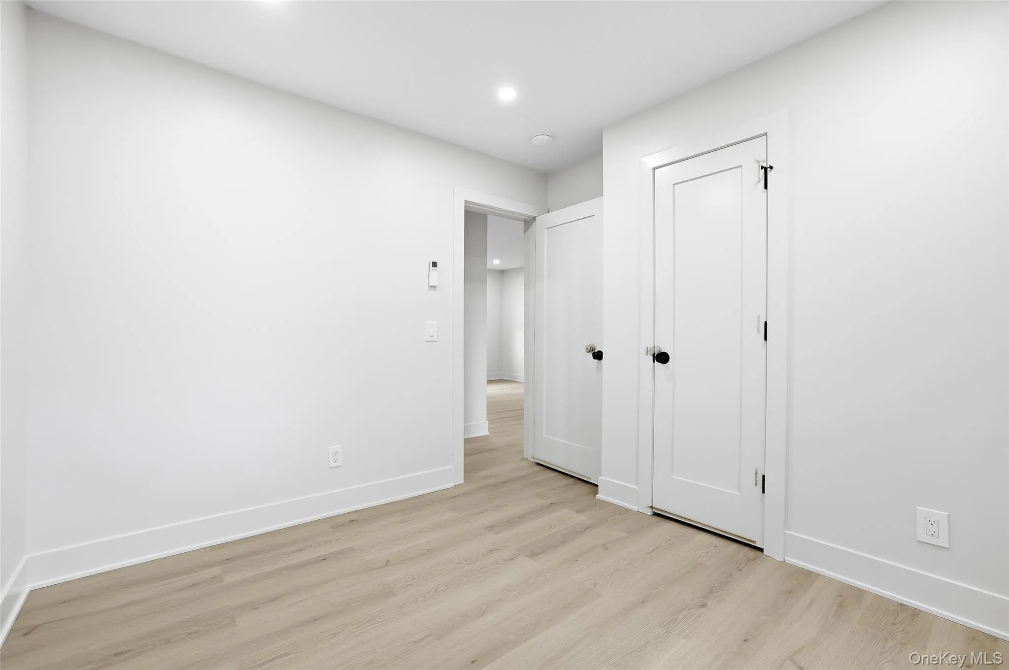 Unfurnished bedroom featuring light wood finished floors and recessed lighting Unfurnished bedroom featuring light wood finished floors and recessed lighting