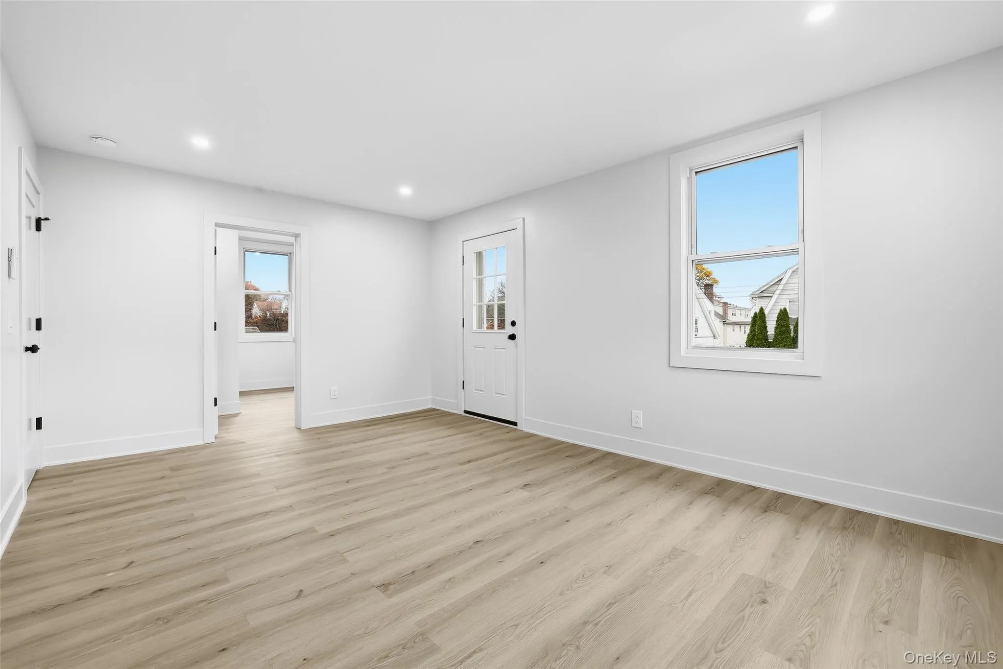 Foyer entrance with light wood-type flooring and recessed lighting Foyer entrance with light wood-type flooring and recessed lighting