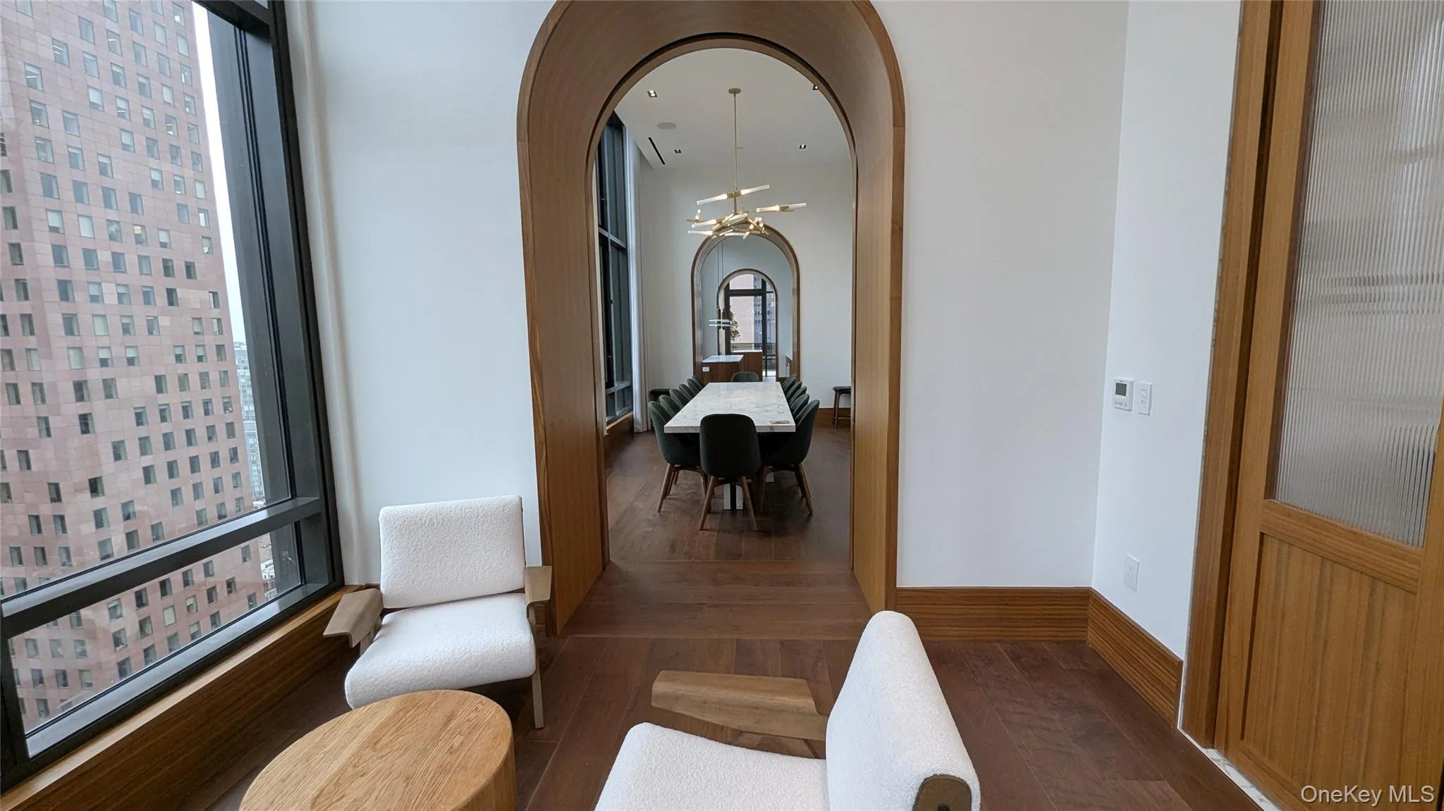 Corridor with arched walkways and dark wood-style floors Corridor with arched walkways and dark wood-style floors