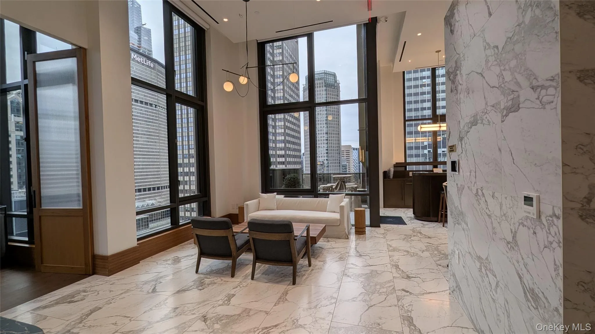 Building lobby with a towering ceiling, a view of city, and a wall of windows Building lobby with a towering ceiling, a view of city, and a wall of windows
