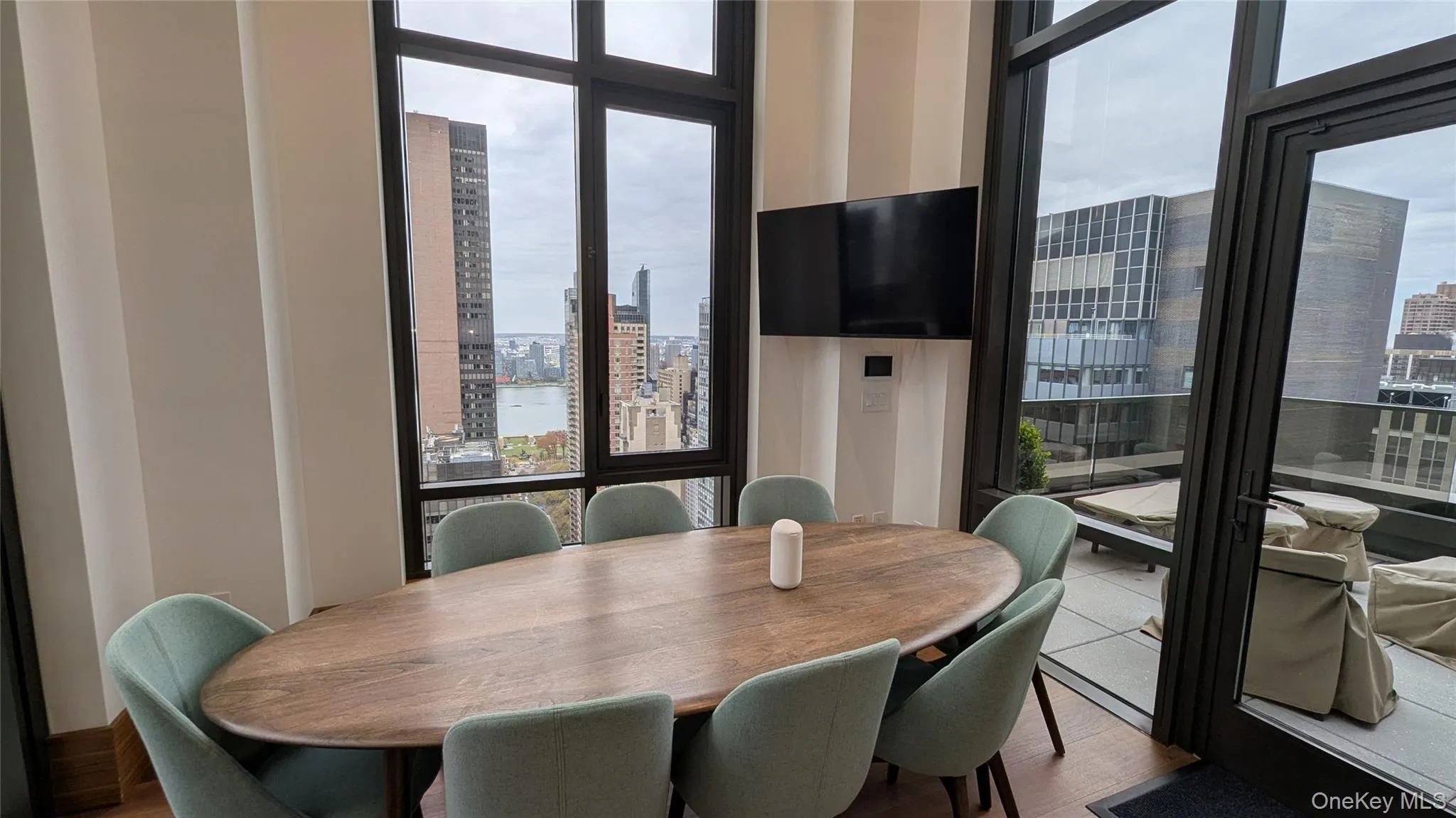 Dining room featuring plenty of natural light, wood finished floors, and floor to ceiling windows Dining room featuring plenty of natural light, wood finished floors, and floor to ceiling windows