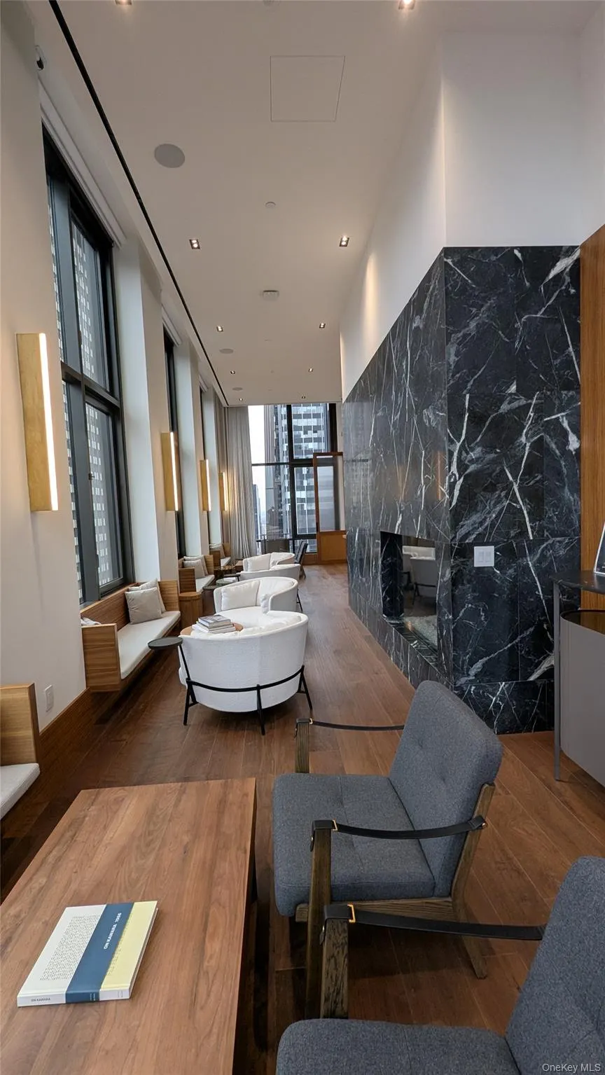 Community lobby featuring a wall of windows and recessed lighting Community lobby featuring a wall of windows and recessed lighting